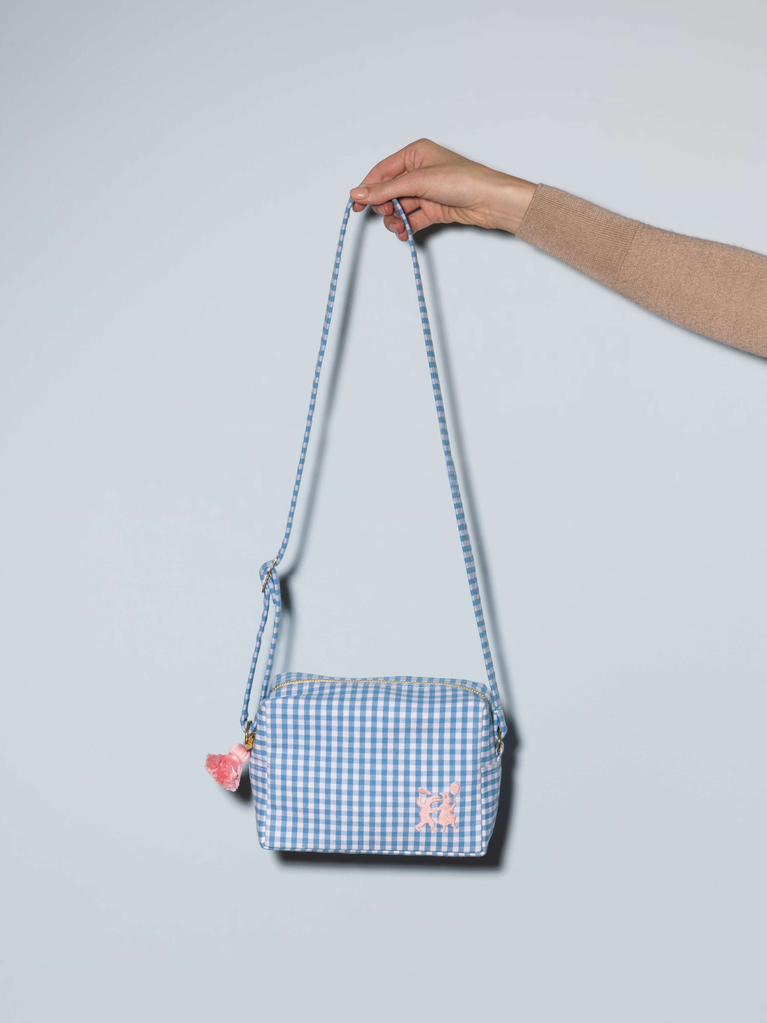 Picture of a kindergarten bag featuring a beautiful lightblue and white vichy check pattern and a cute pink rabbit embroidery 