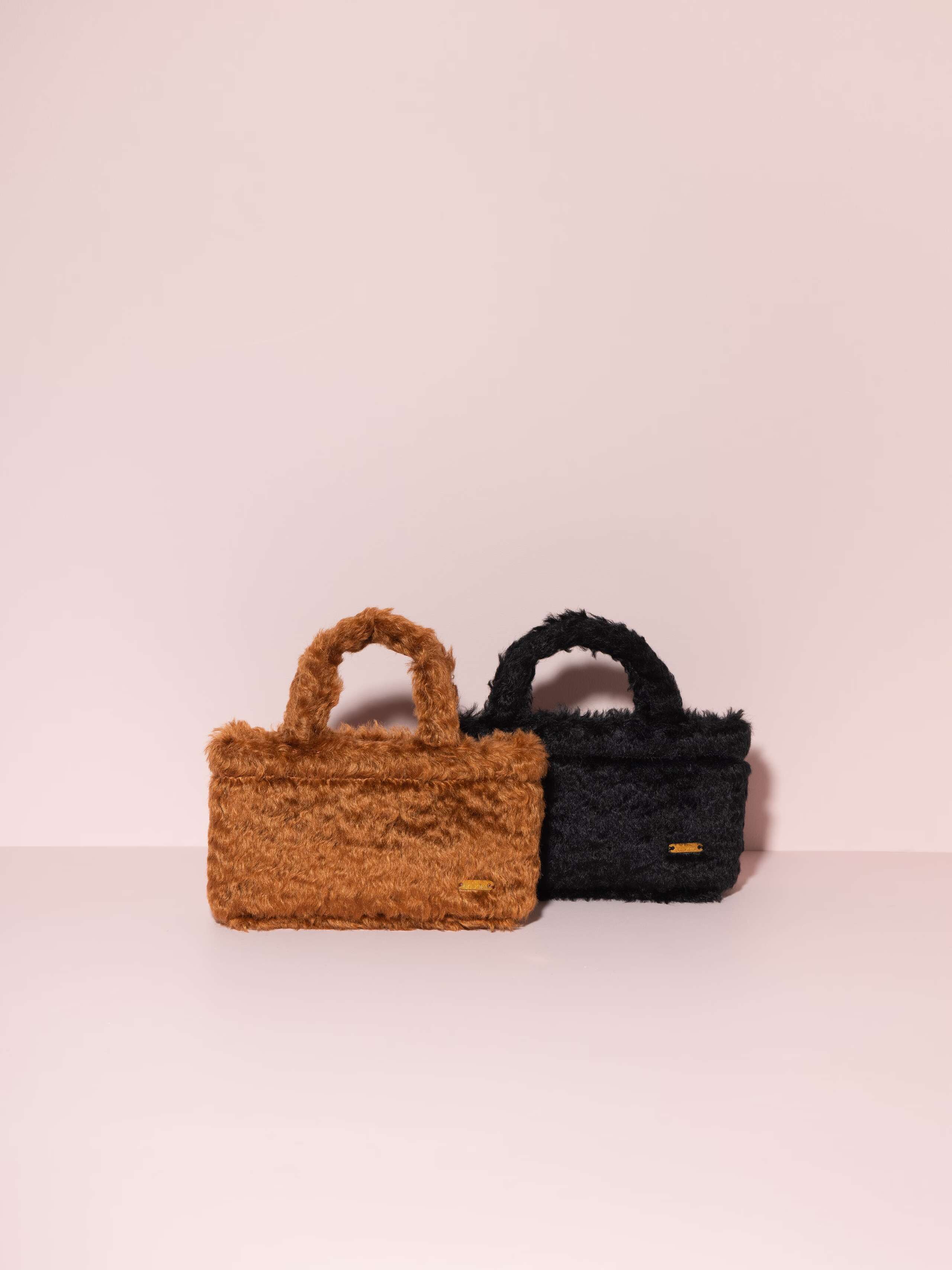 Picture of two small hand bags made of cognac and black coloured mohair fabric
