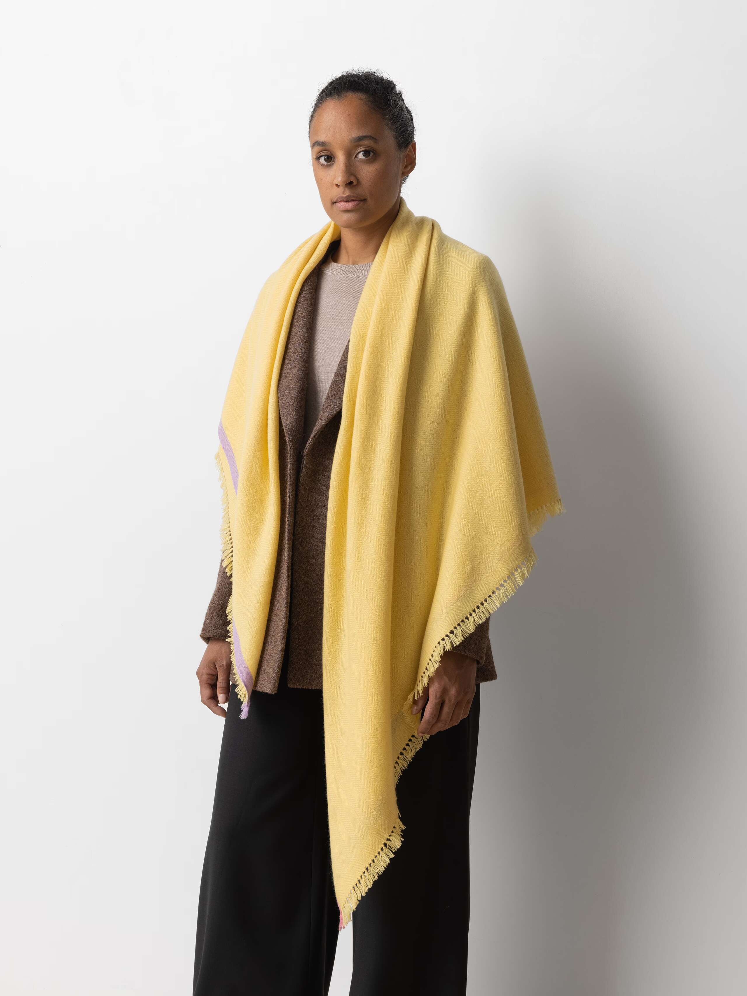 Picture of a model wearing a bright yellow cashmere stole