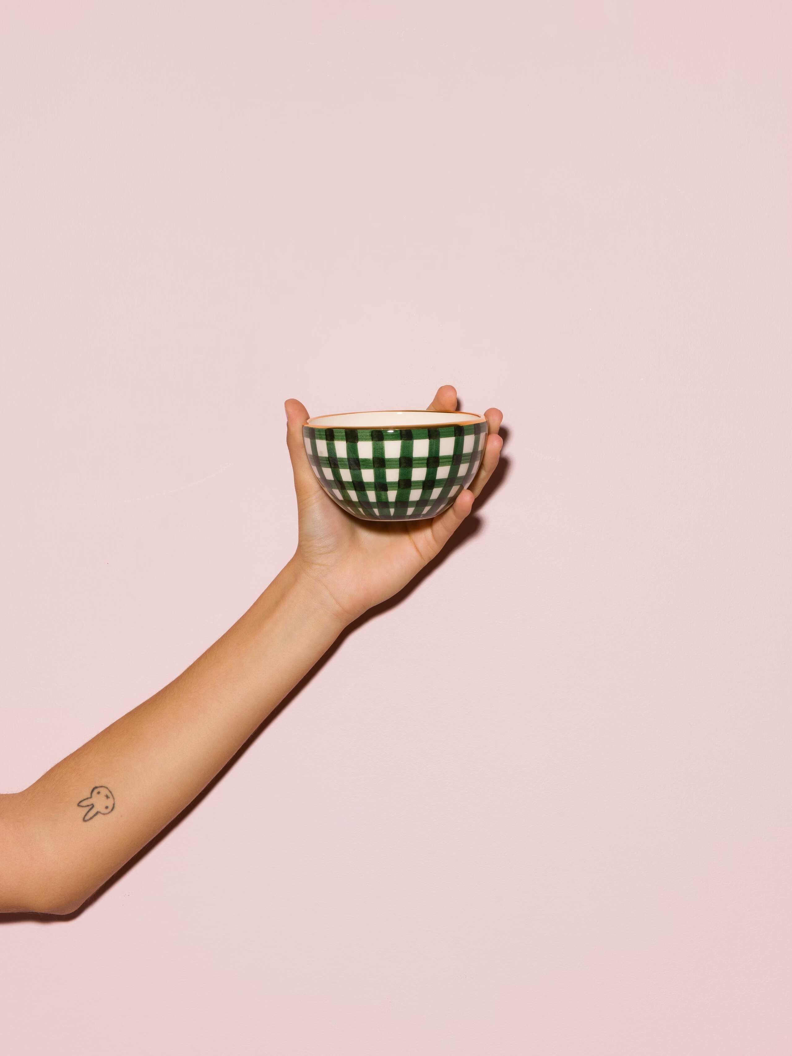 Picture of a small bowl featuring a green vichy check pattern