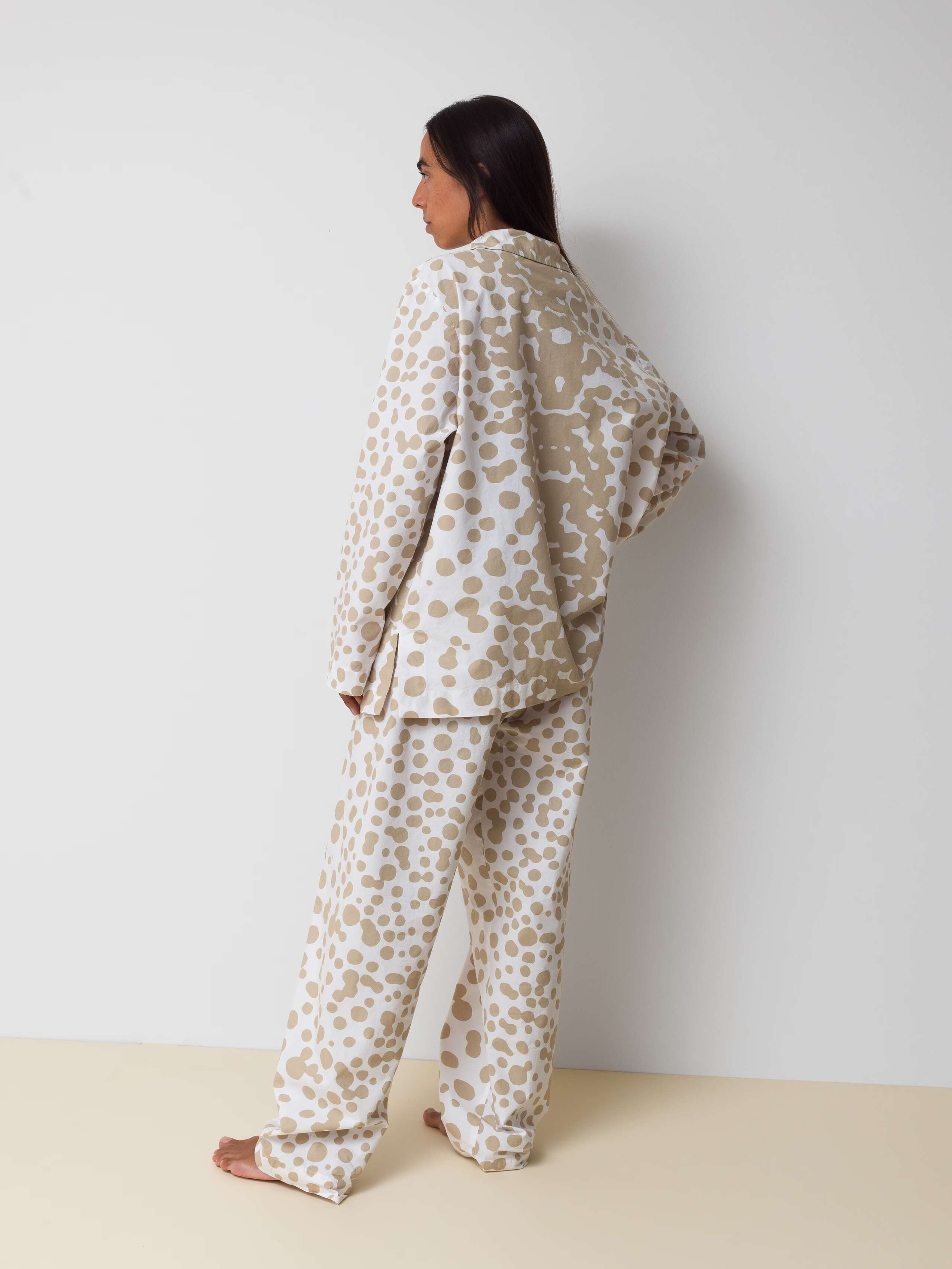 Picture of a women wearing a cotton pyjama featuring beige dots