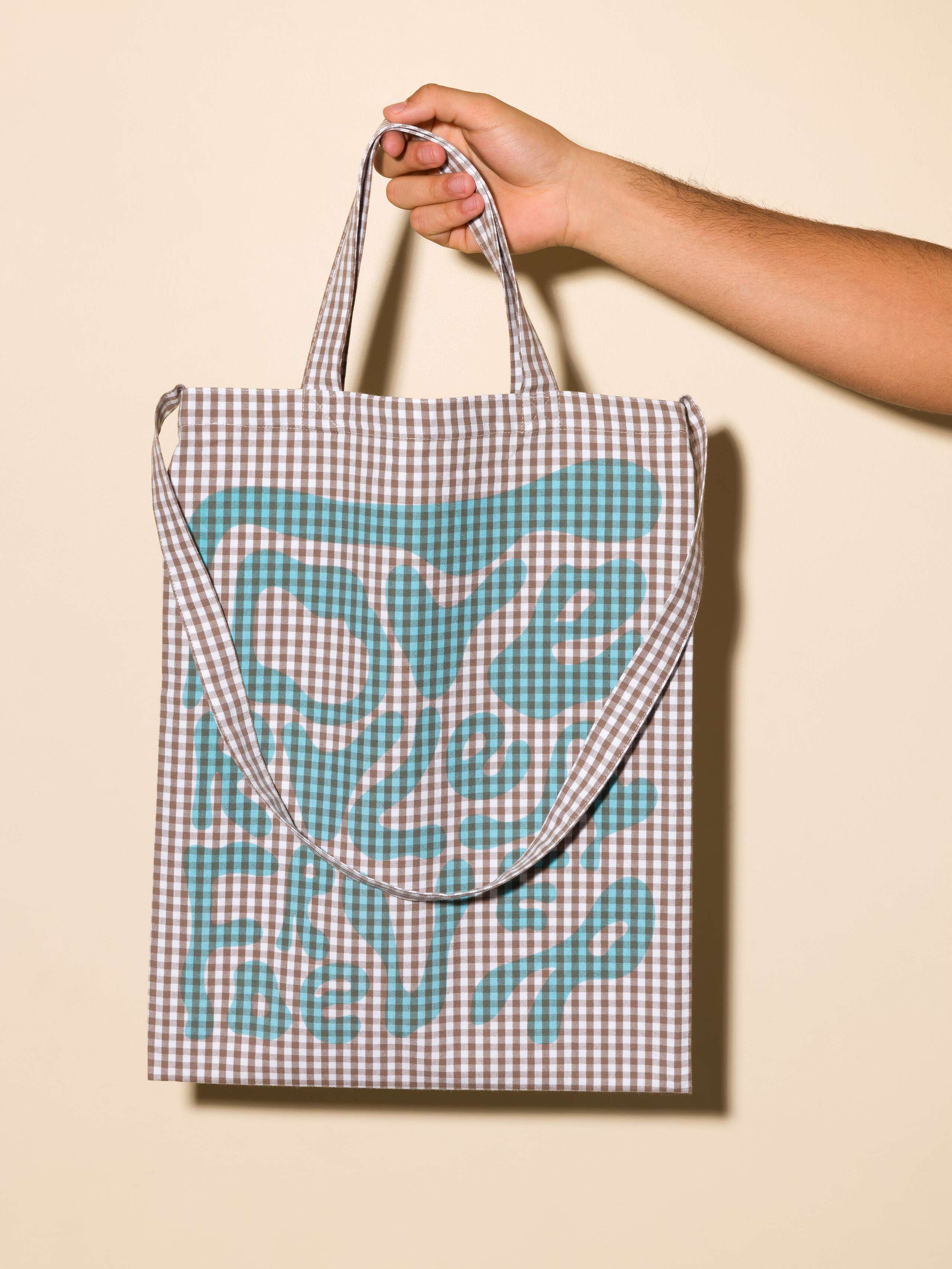 Picture of a tote bag featuring a beautiful beige check pattern and the motto Love Rules Forever