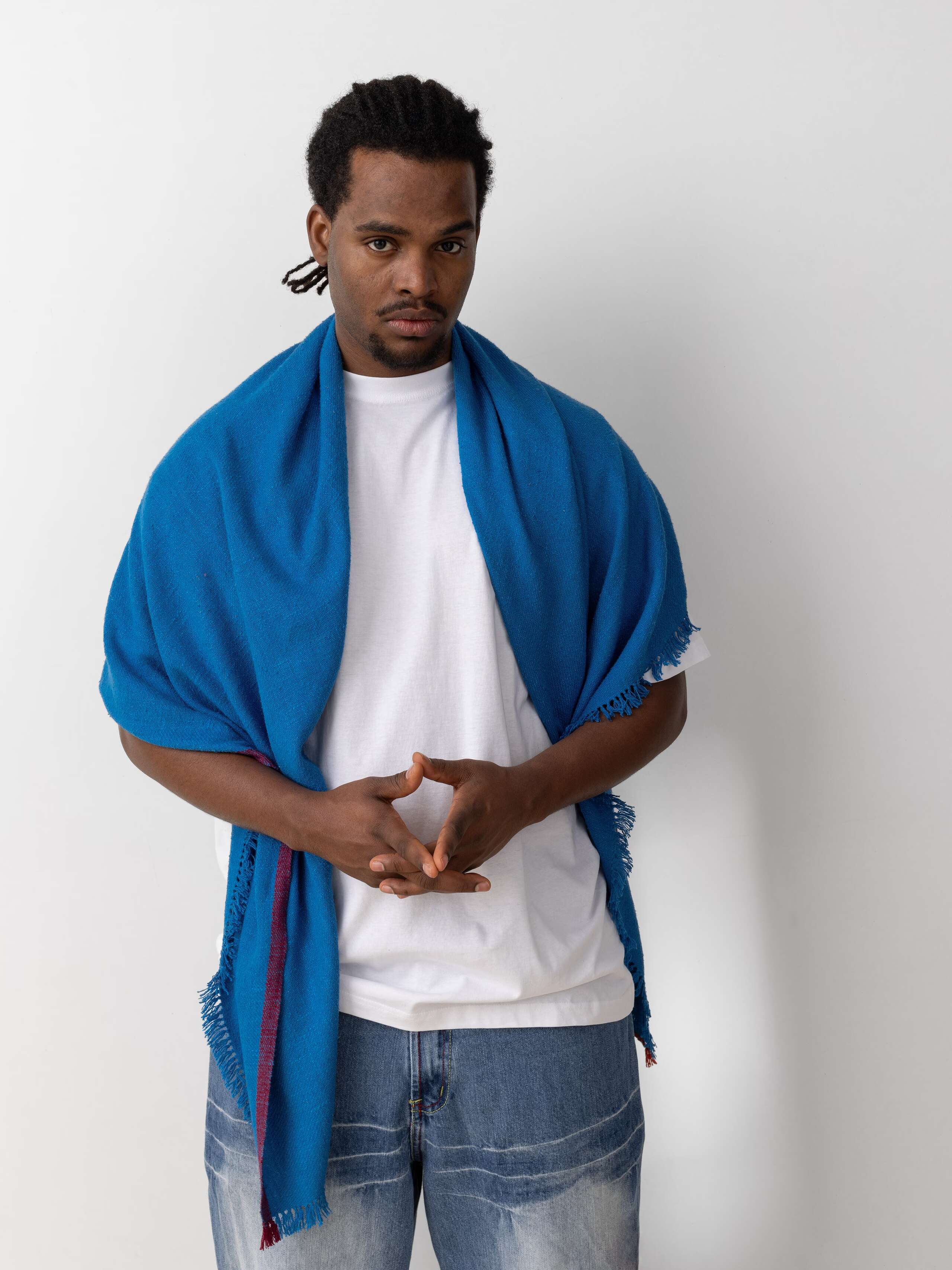 Picture of a model wearing a blue silk stole over his shoulders