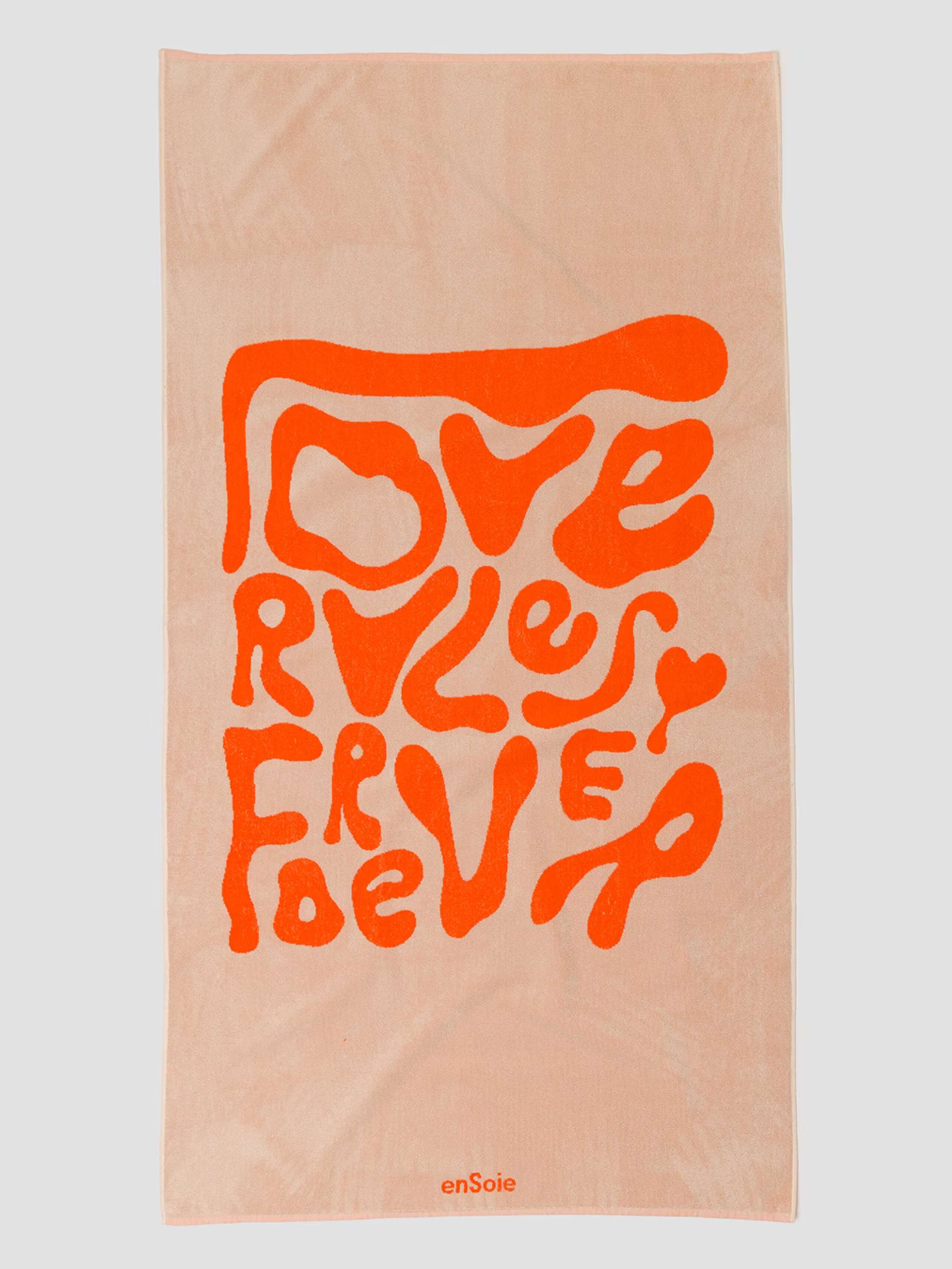 Picture of a frotté bath towel in orange featuring an orange LOVE RULES FOREVER motto