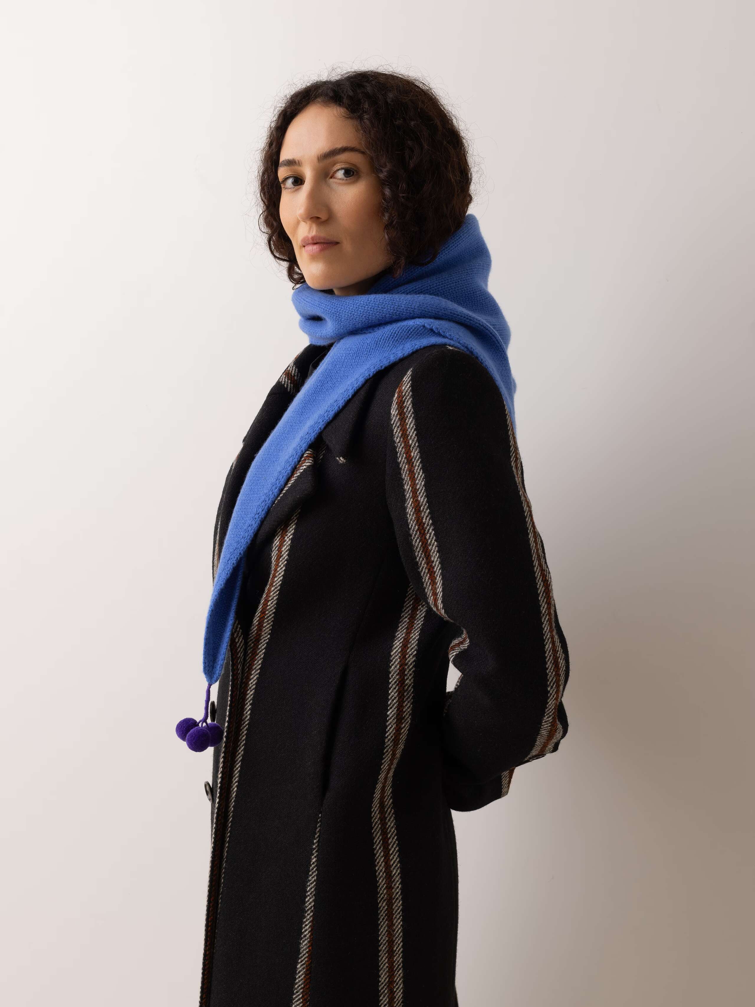 Knitted Pia cashmere triangle scarf with pompon detail in palermo blue