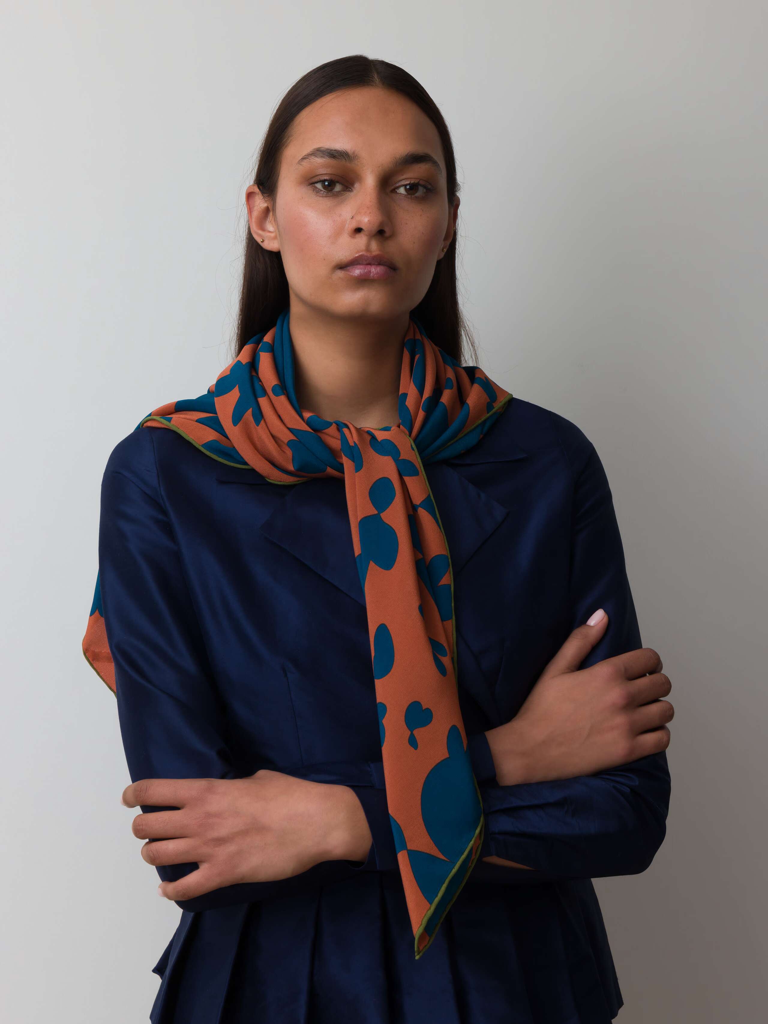 Model wearing inspired hearts silk foulard in brown and blue