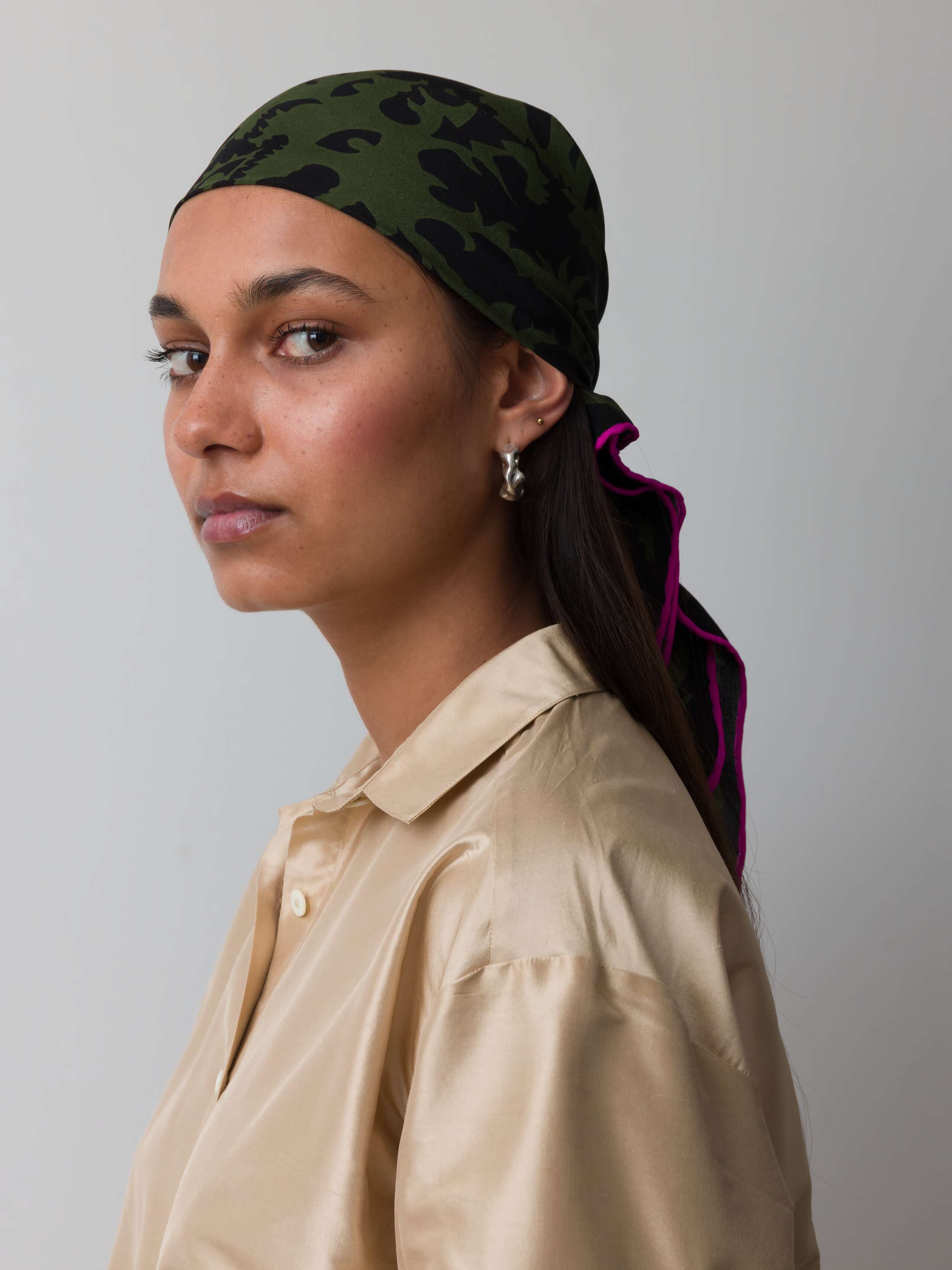Model wearing silk foulard in green monster print