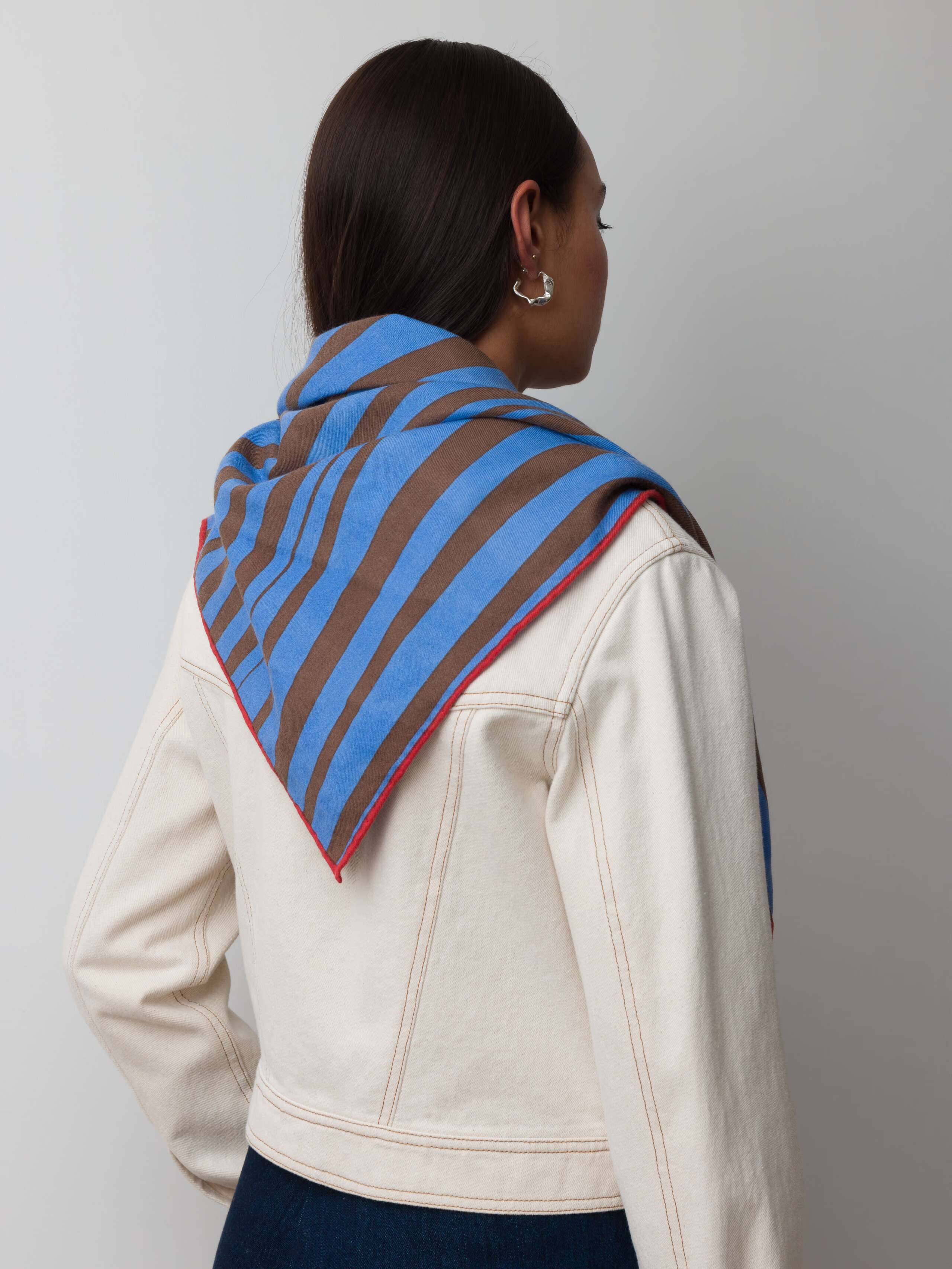 Model wearing wool foulard striped in blue and brown