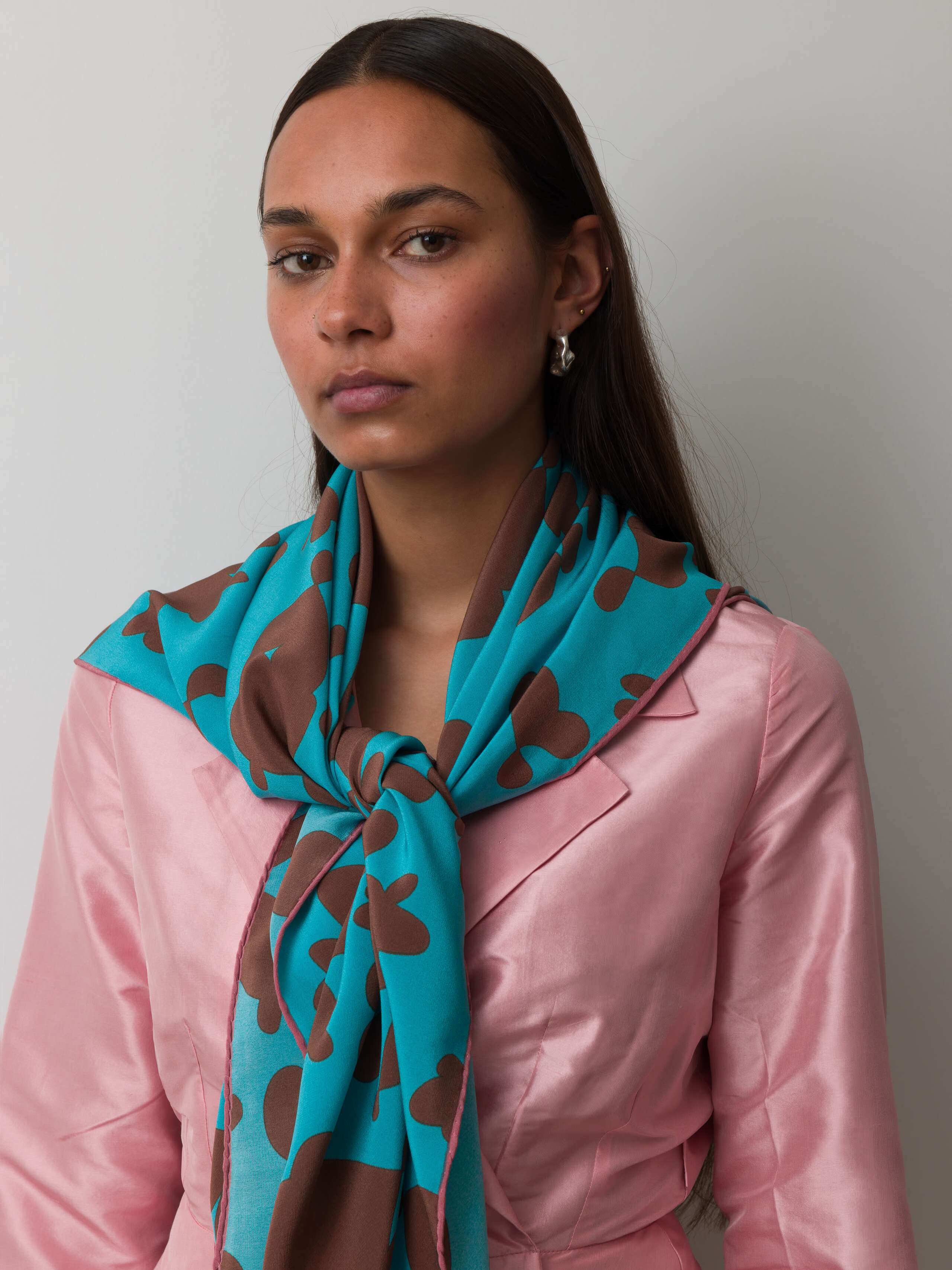 Model wearing inspired hearts foulard teal brown