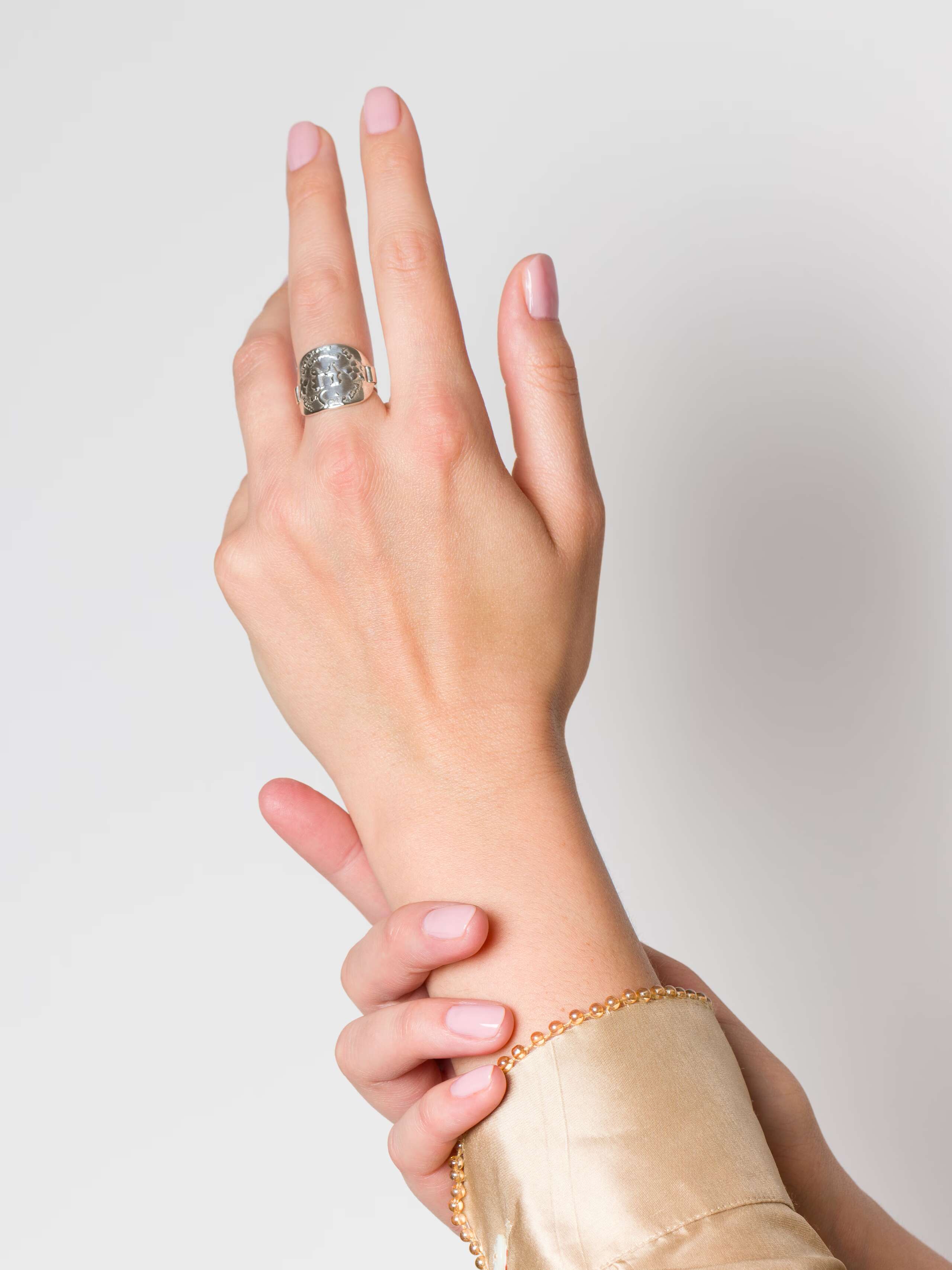 Model wearing enSoie logo tag ring