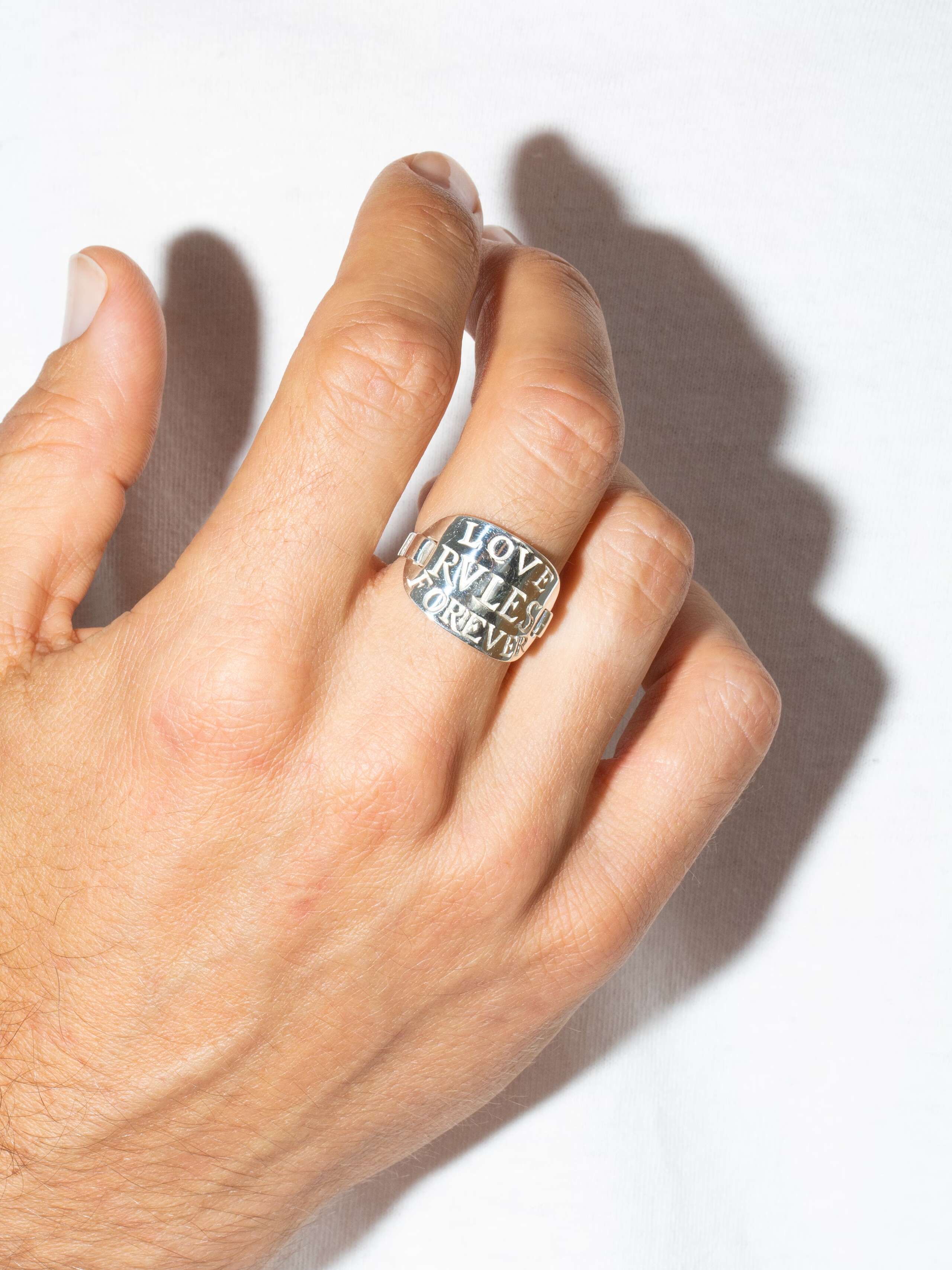 Male model wearing love rules forever tag ring