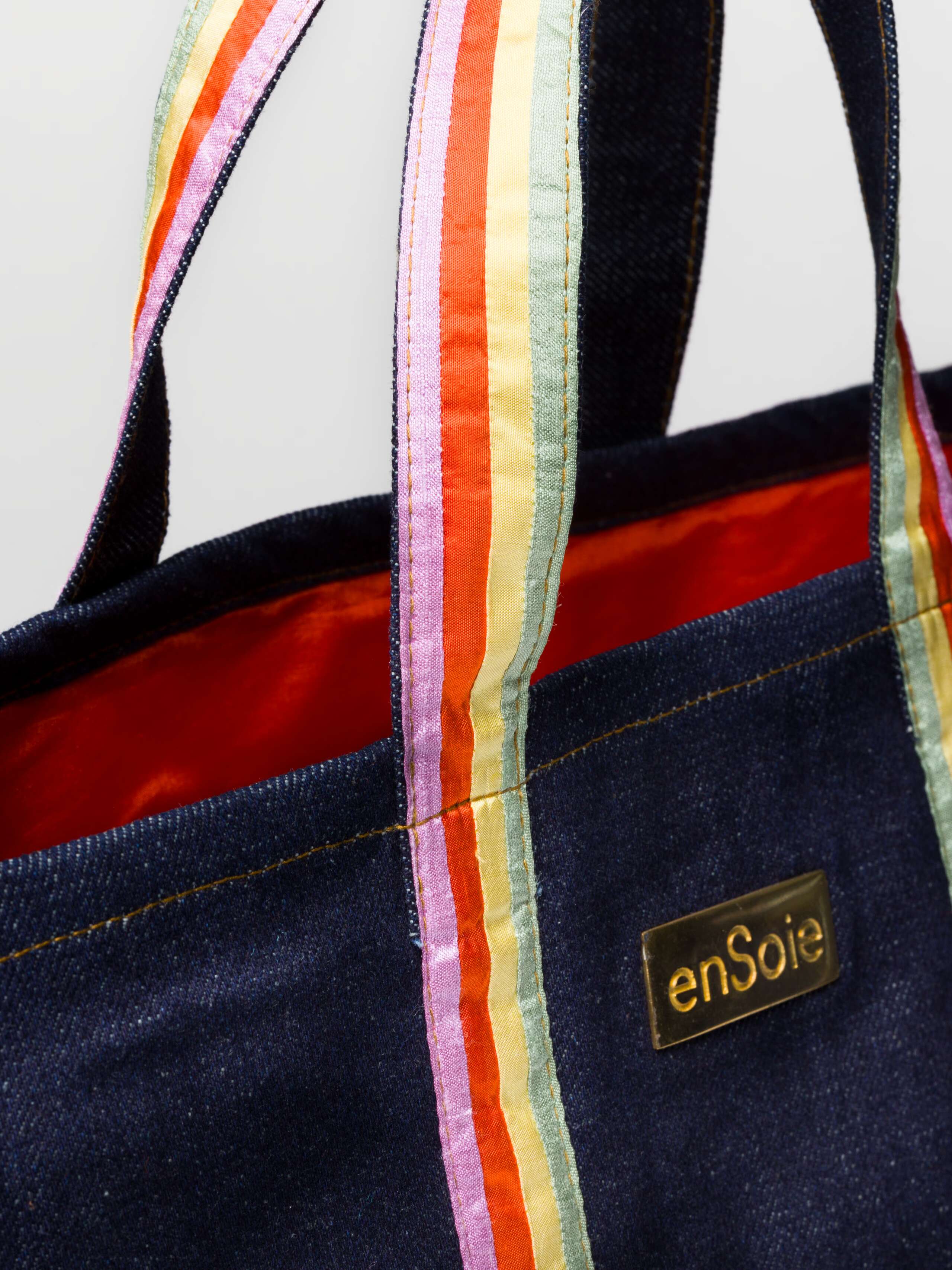 Upstate bag in denim featuring handles in three doupion silk colours combined and brasstag featuring ensoie logo in three sizes