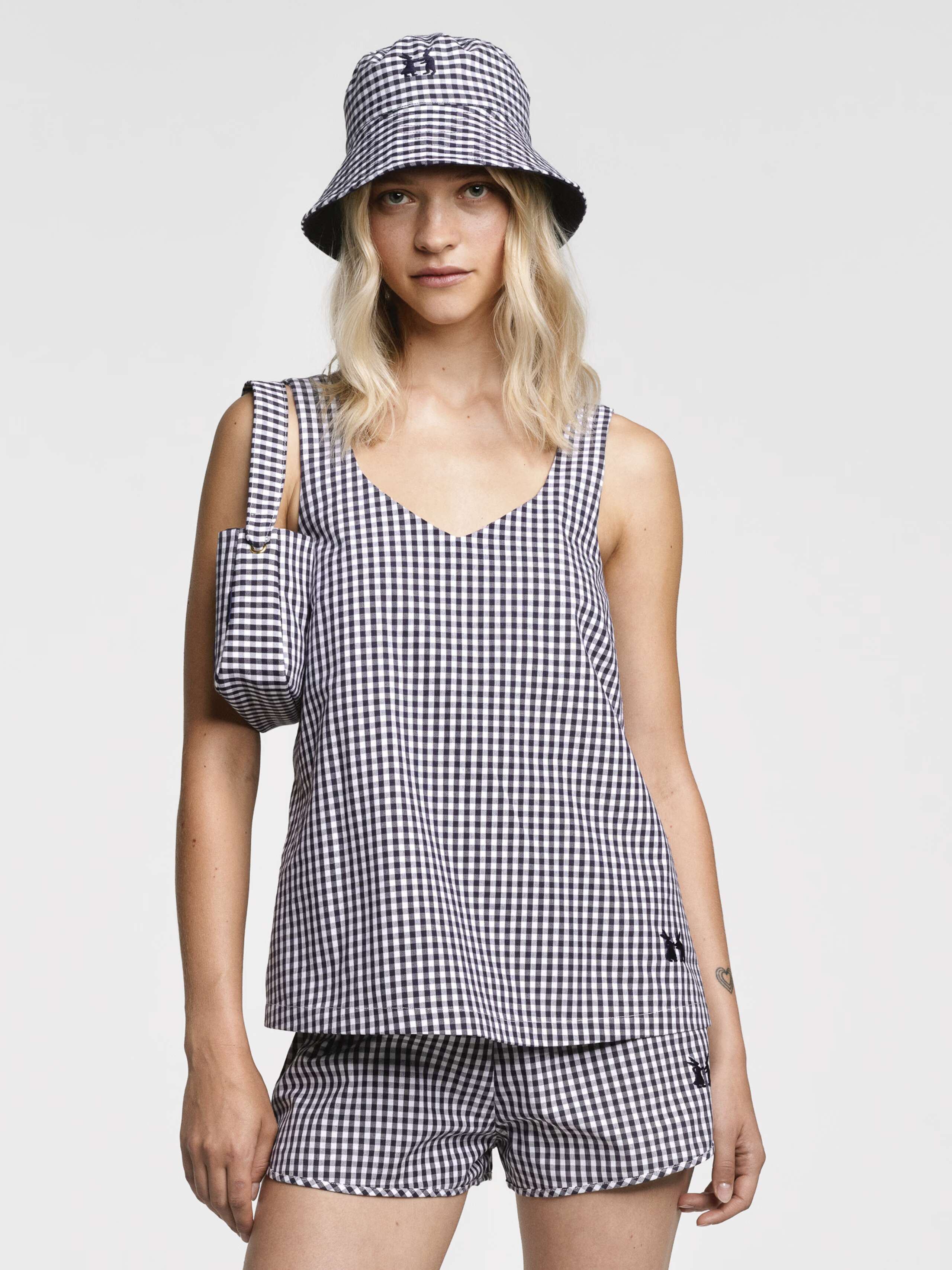 Model wearing the sleeveless Tia top in Navy vichy check and matching Dionne shorts