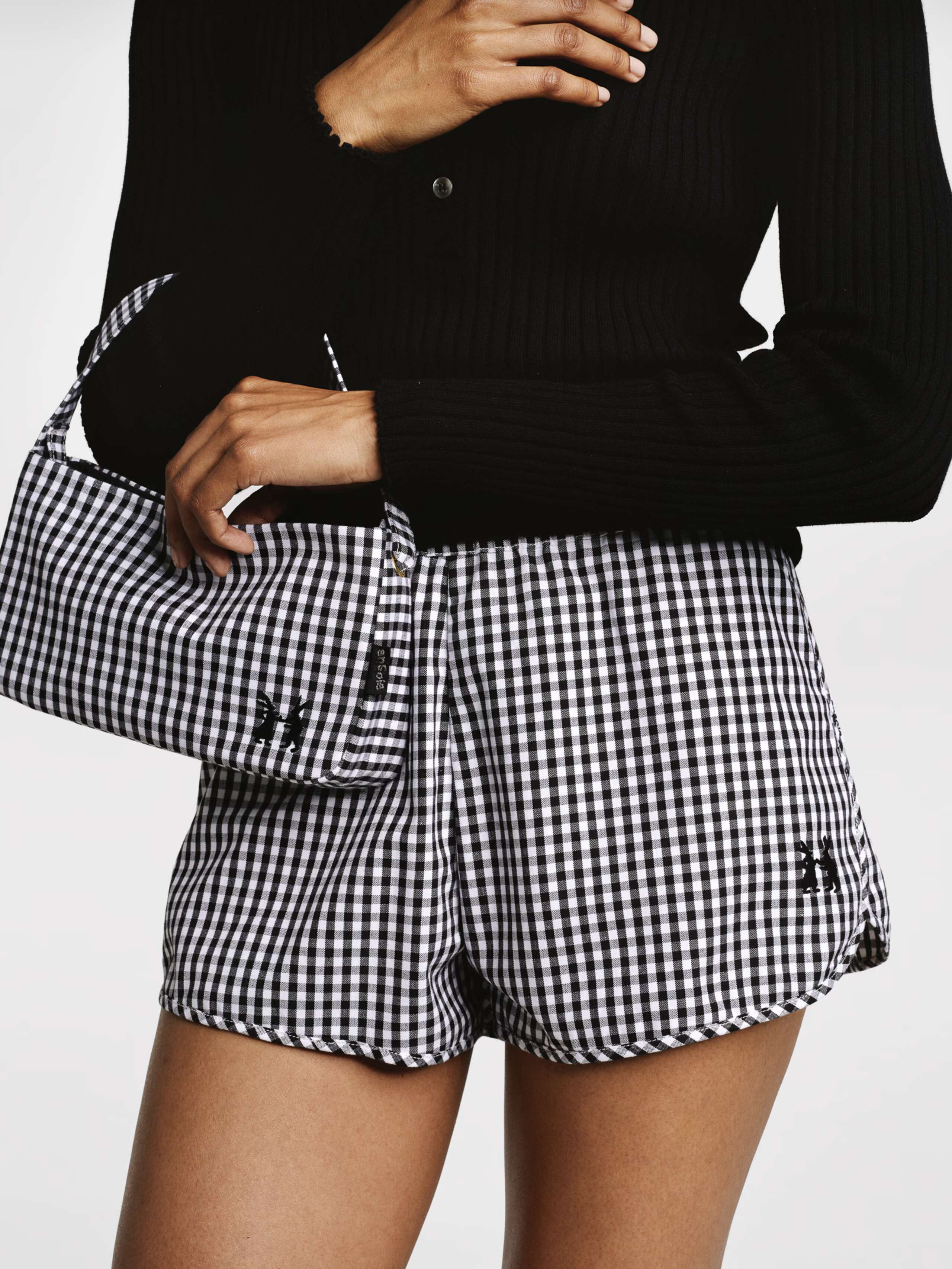 Model wearing the black vichy check dionne shorts