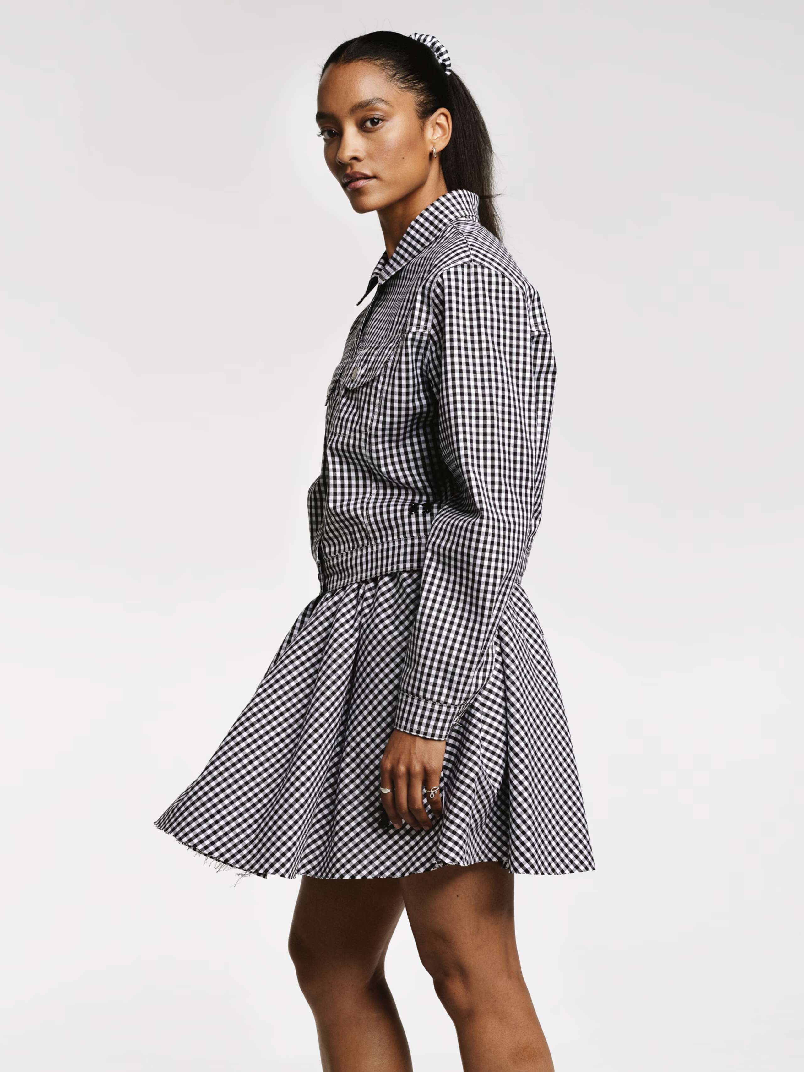 Model wearing the Berta short skirt in vichy check black