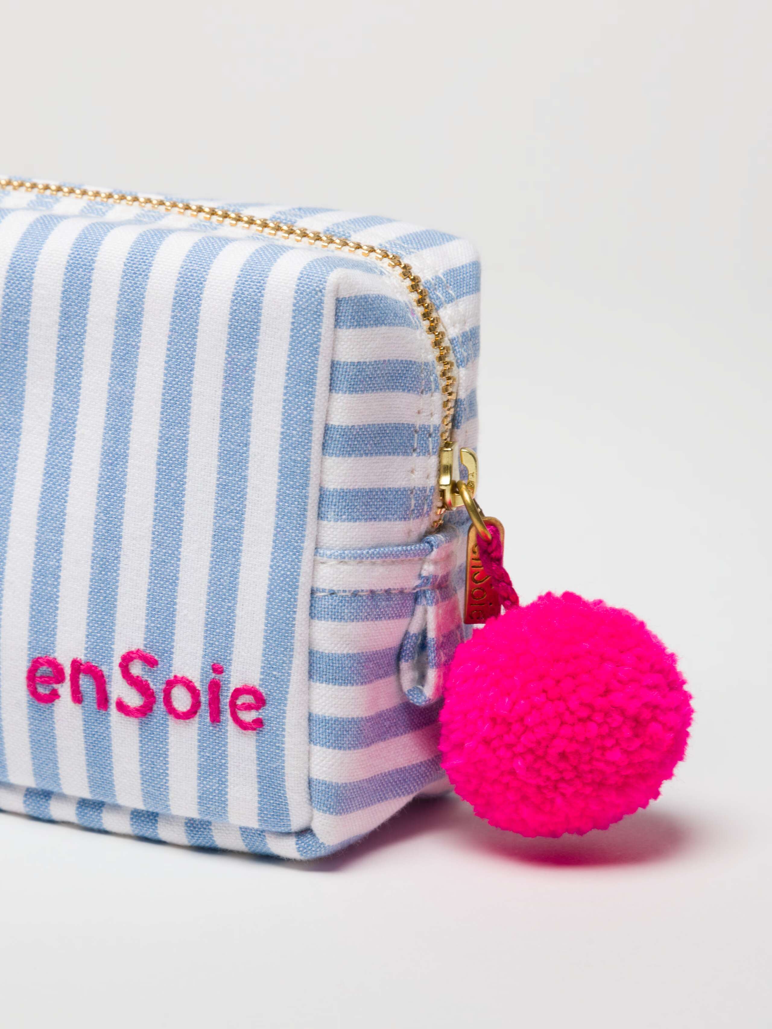 Linda toiletry bags in cerulean blue with pink pom pon