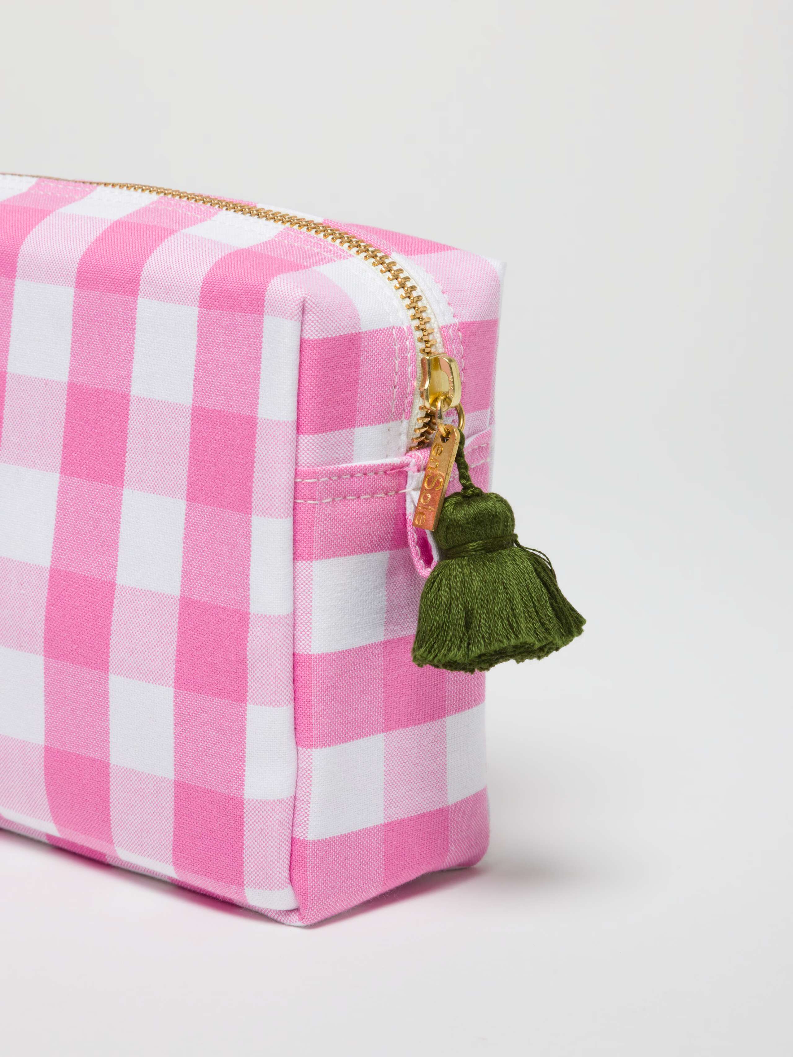 Close up pf Tilda in rose garden with an olive green tassel