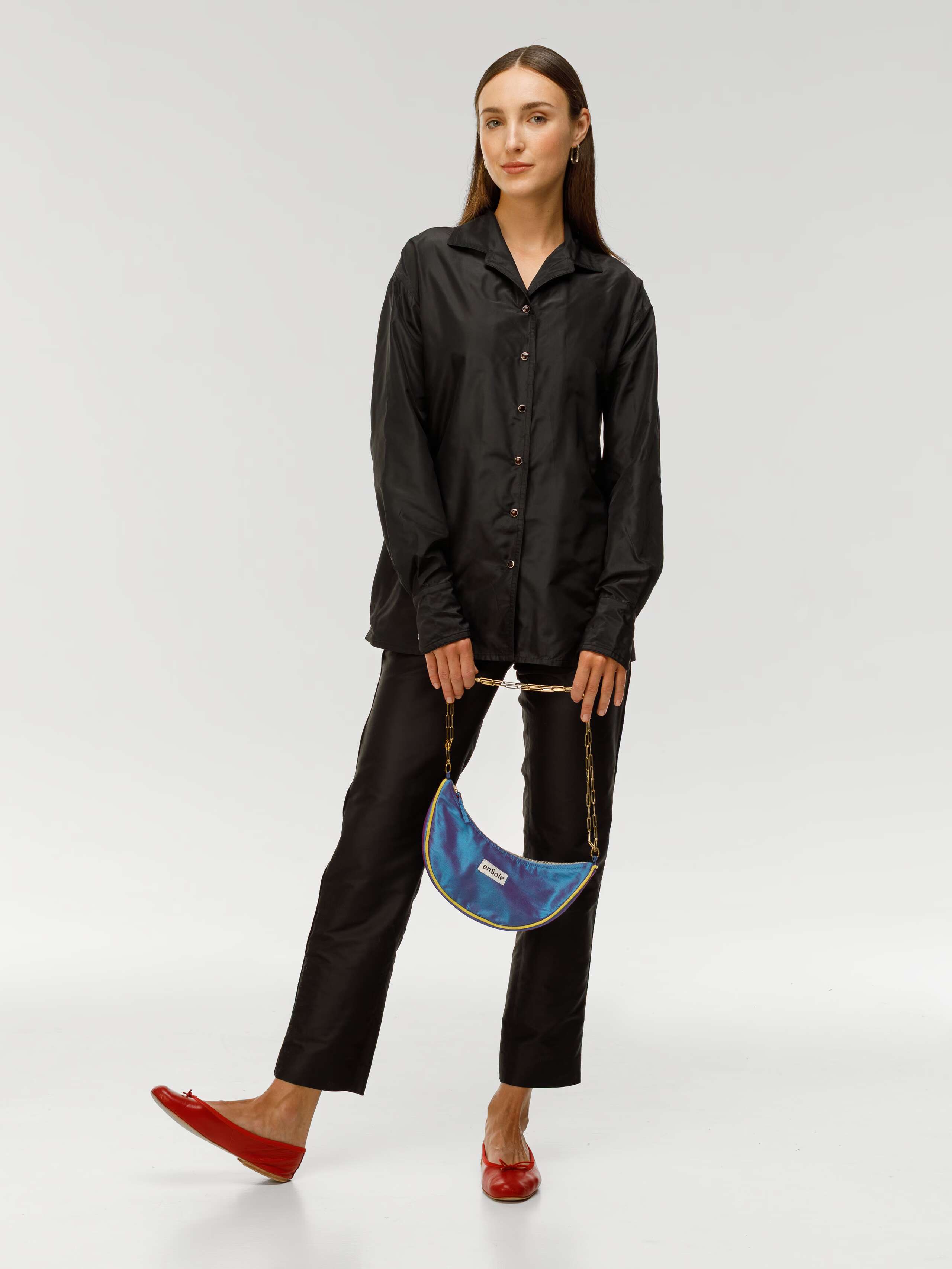 Model holding moon bag in funky blue