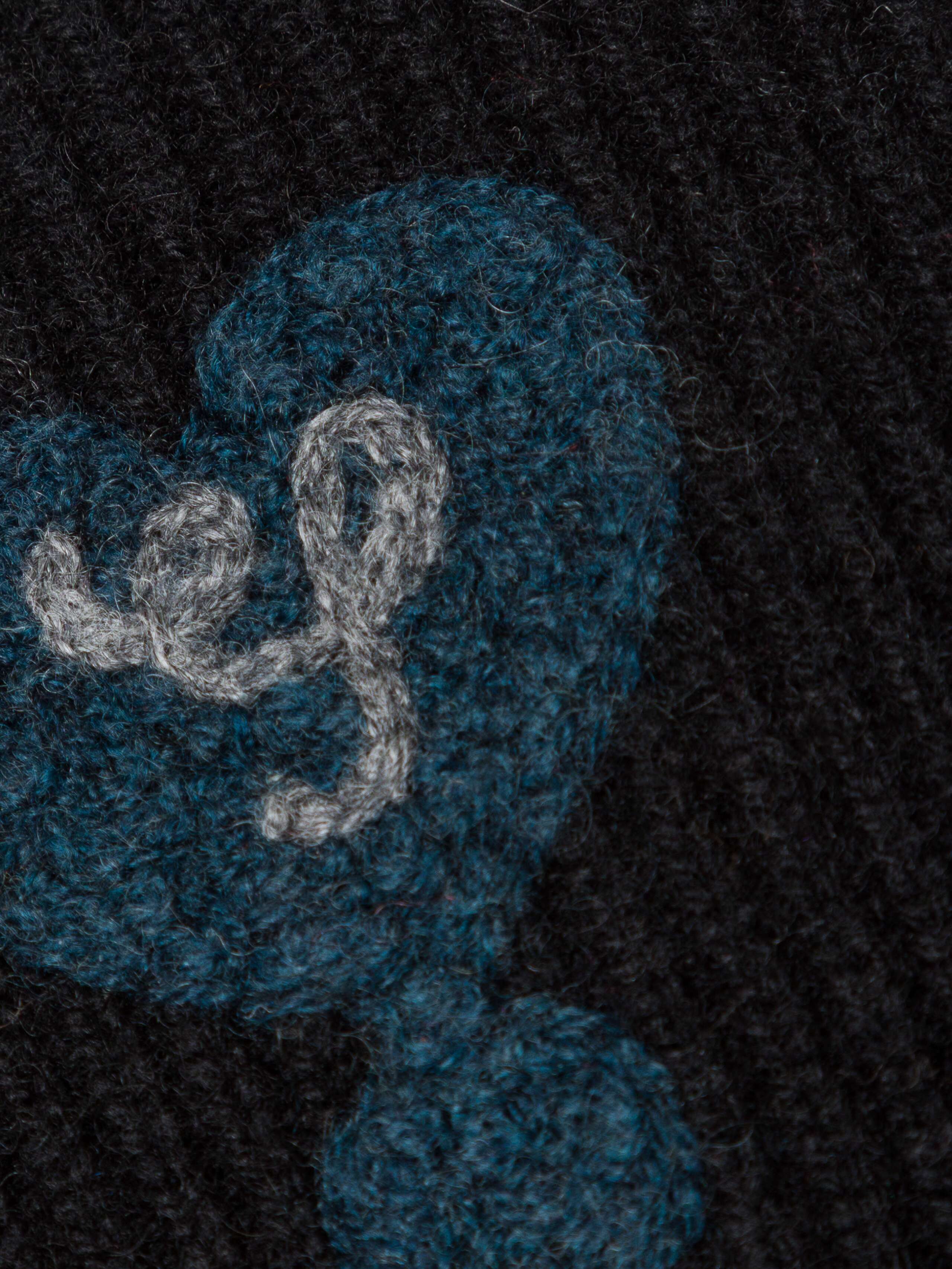 Picture of a heart detail of a navy cashmere wrist warmer
