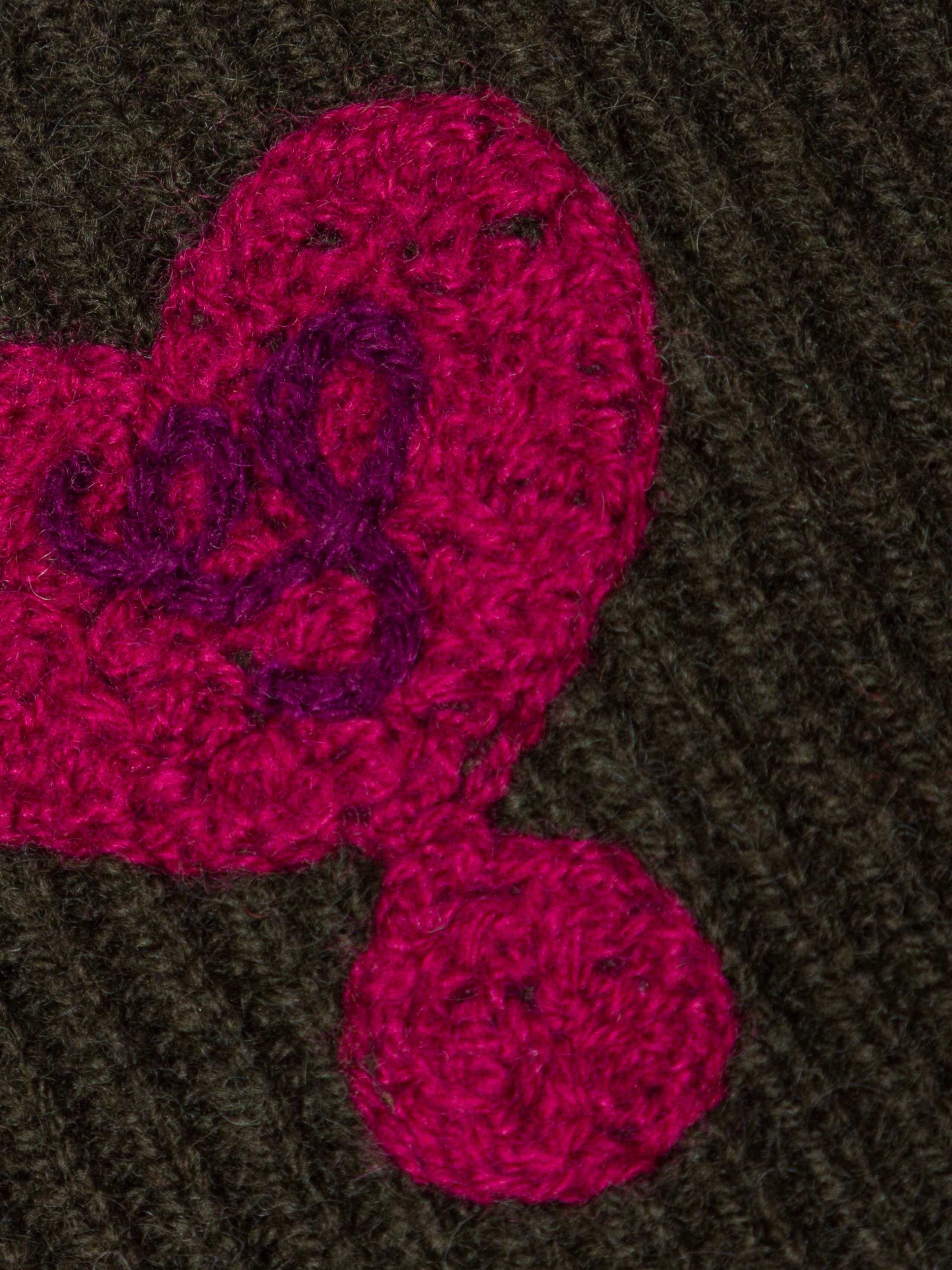 Picture of a heart detail of a green cashmere wrist warmer