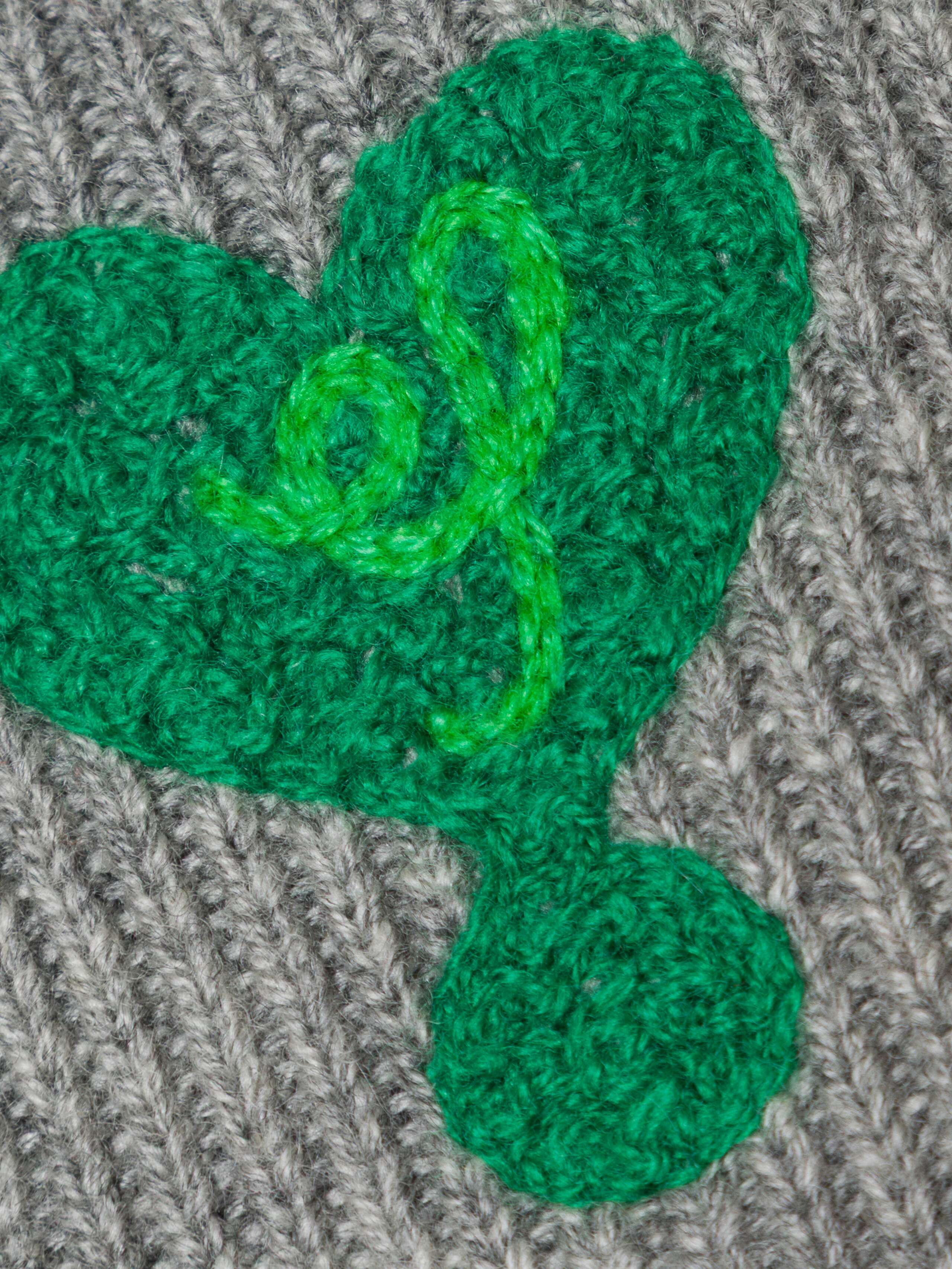 Picture of a heart detail of a grey cashmere wrist warmer