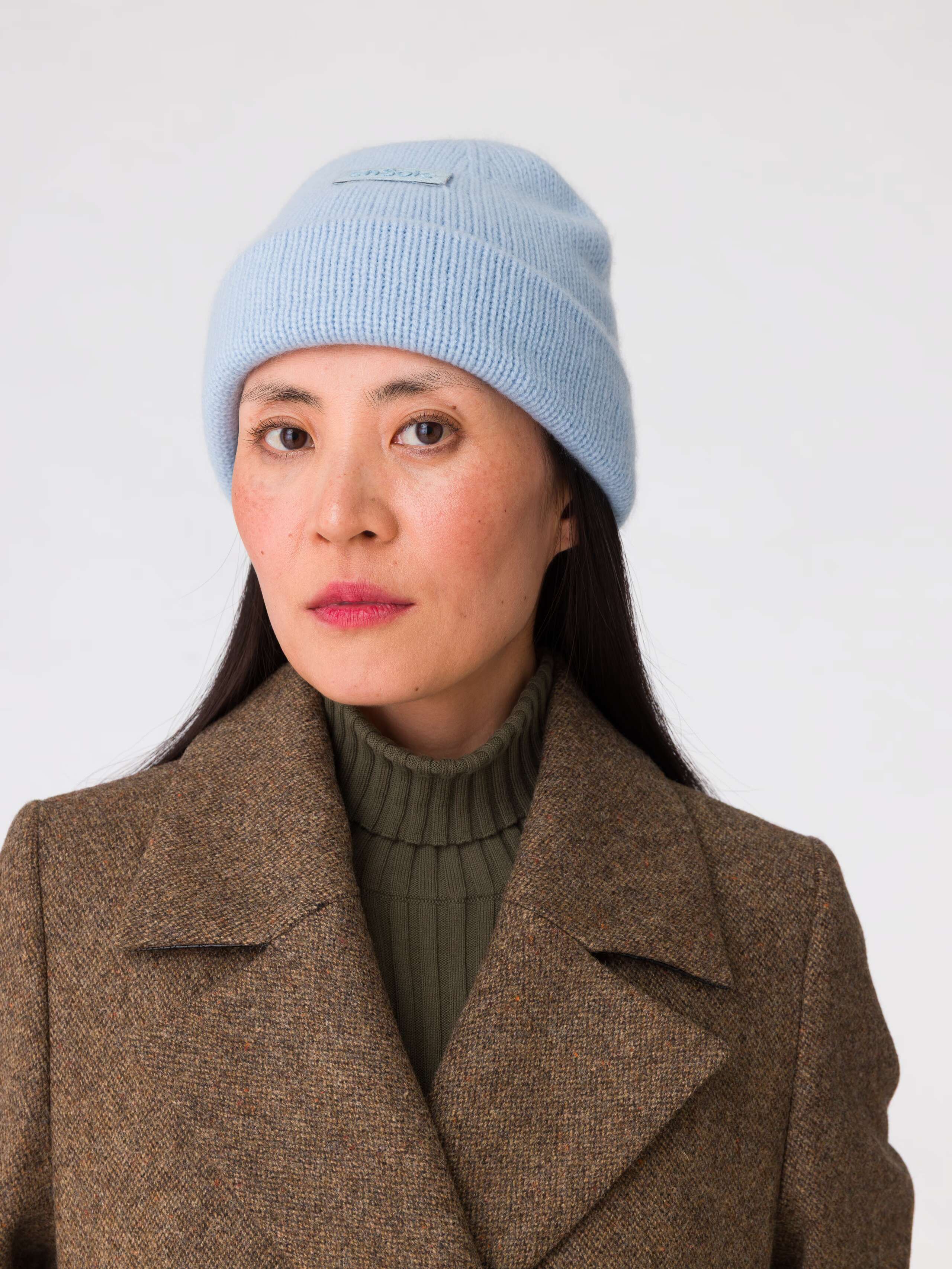 Picture of a women wearing a light blue cashmere beanie