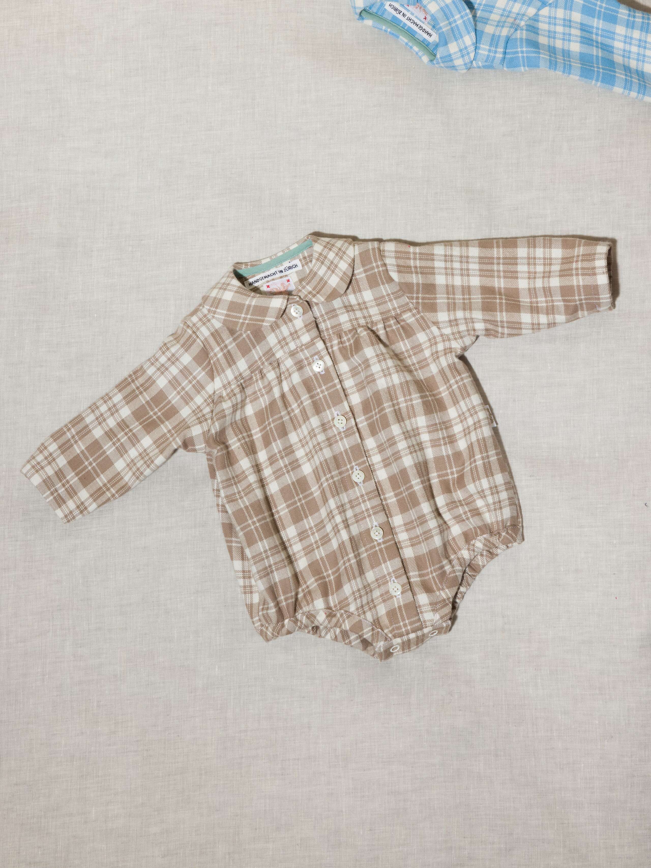Beautiful handmade cotton flannel baby body in a soft check pattern with long sleeves, moonrock beige