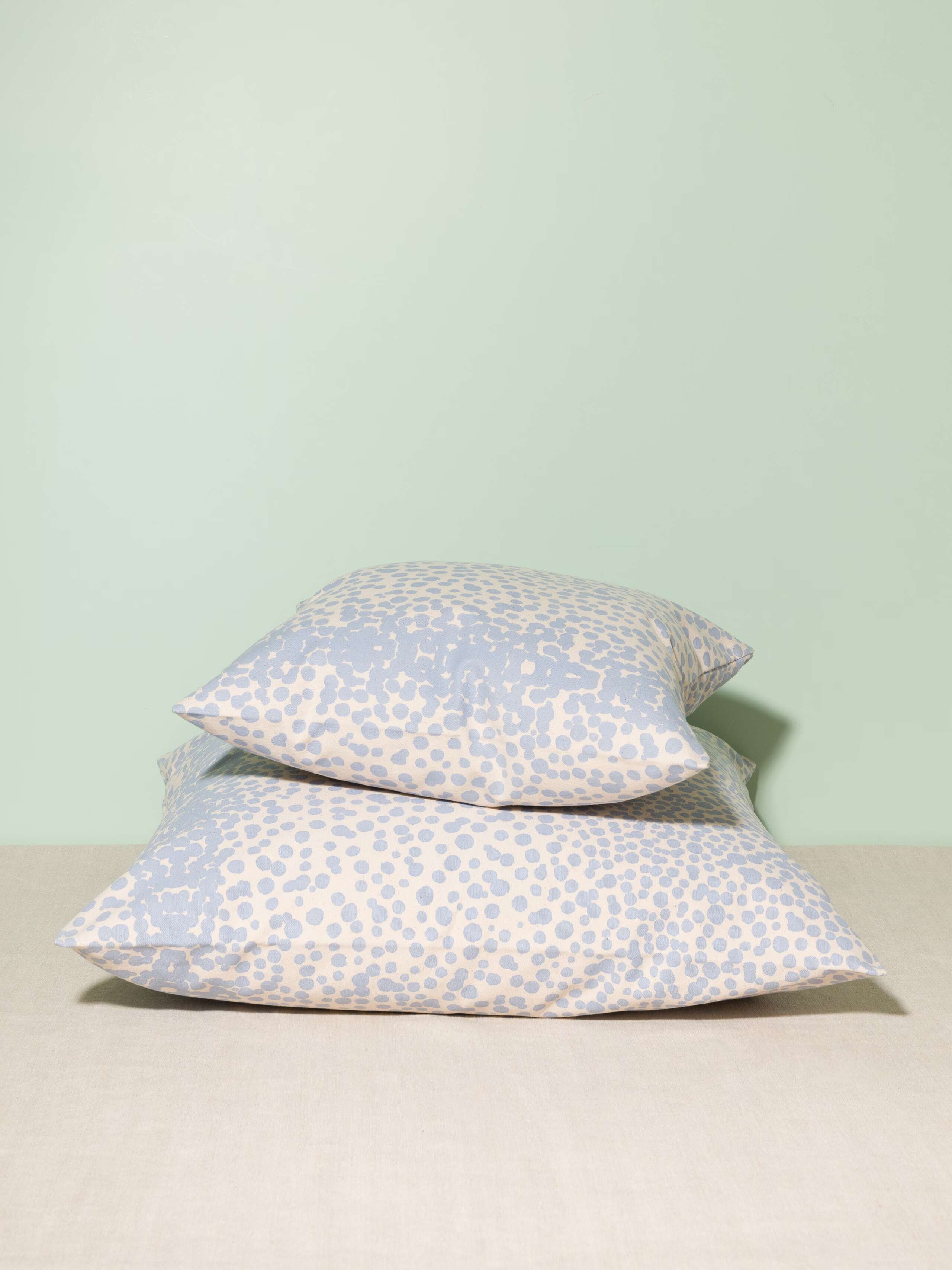 Picture of two pillow covers made of cotton canvas featuring light blue dots