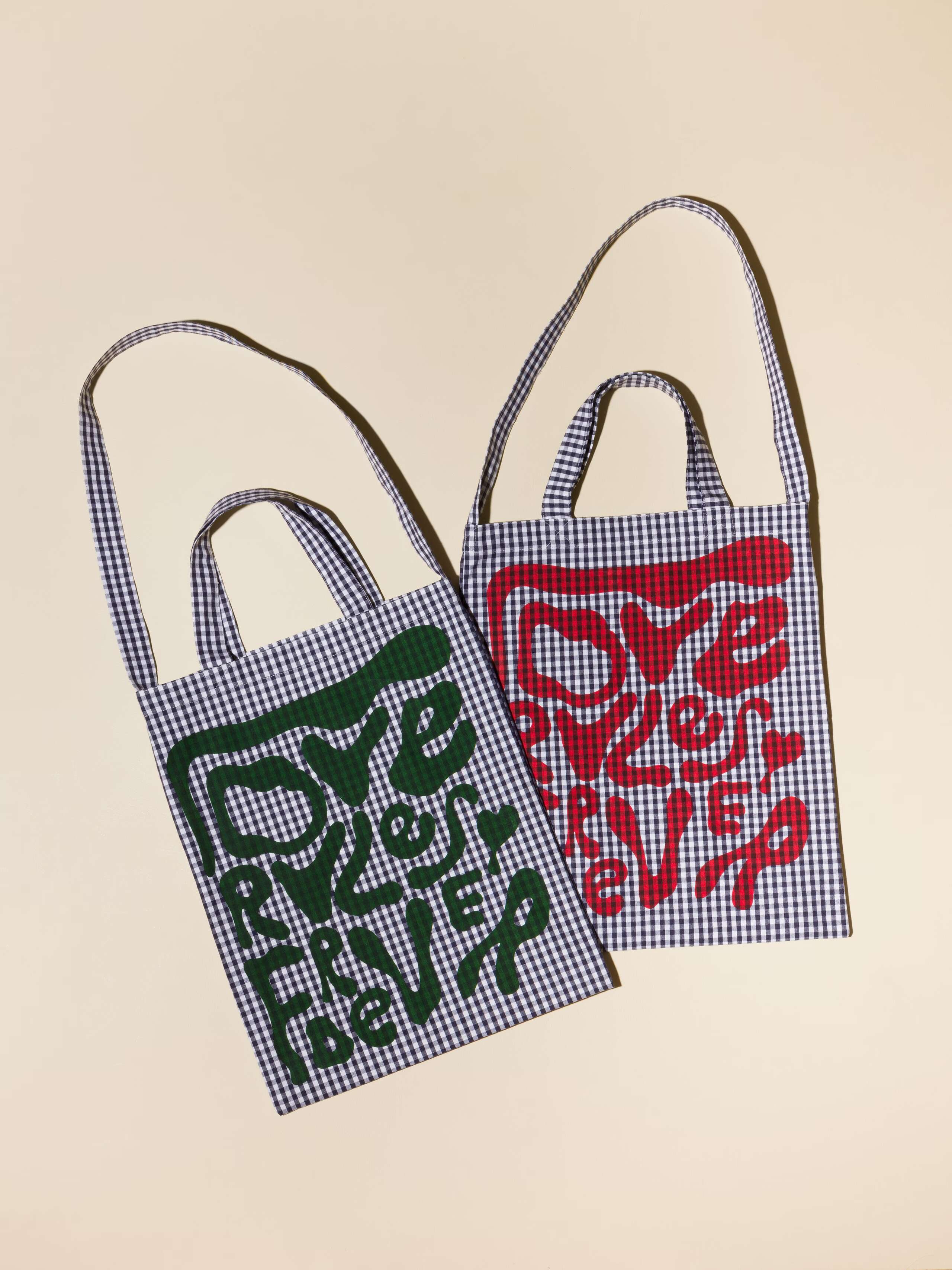 Picture of two tote bags featuring a navy blue vichy check pattern