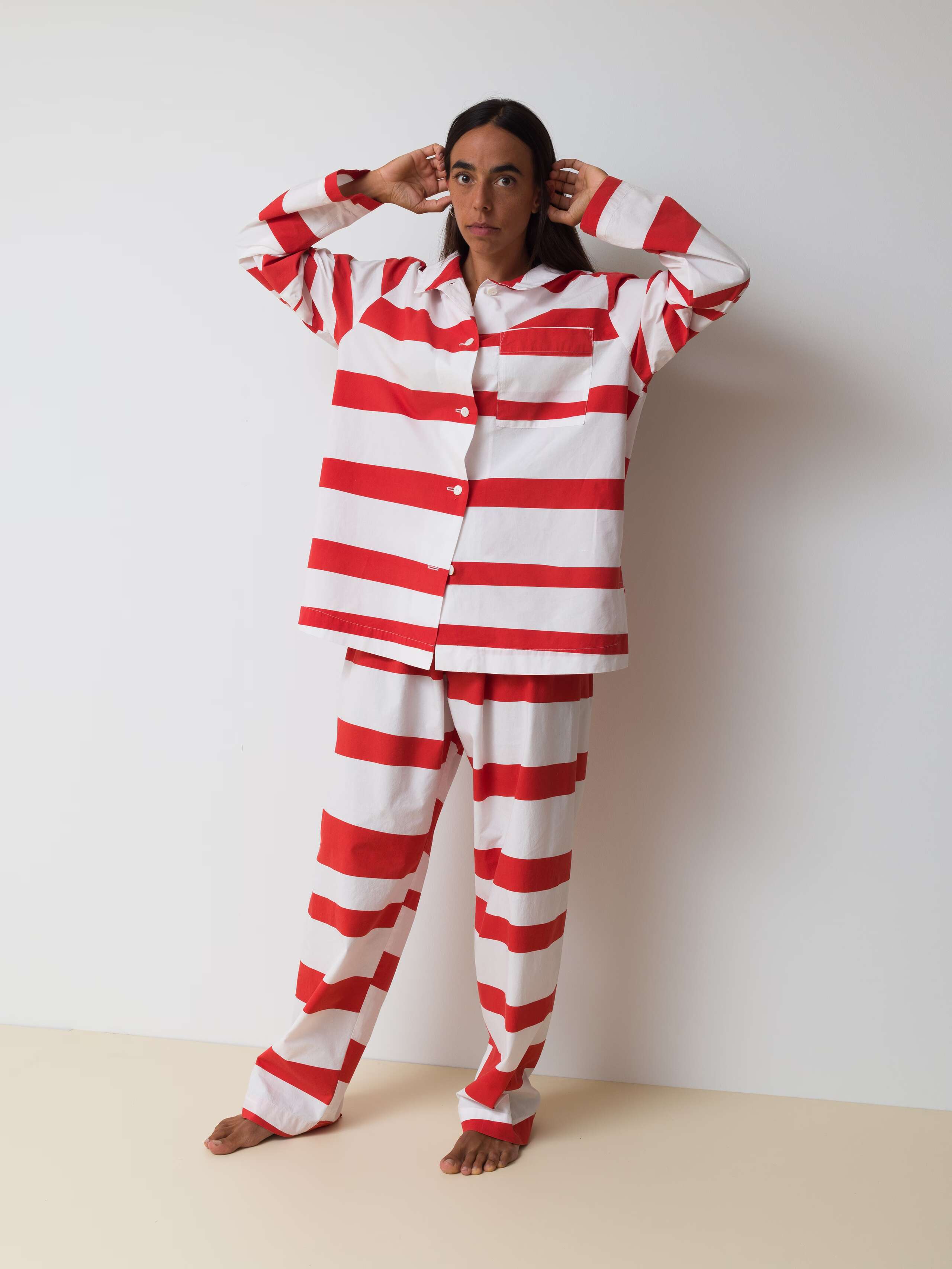 Picture of a women wearing a cotton pyjama featuring red stripes