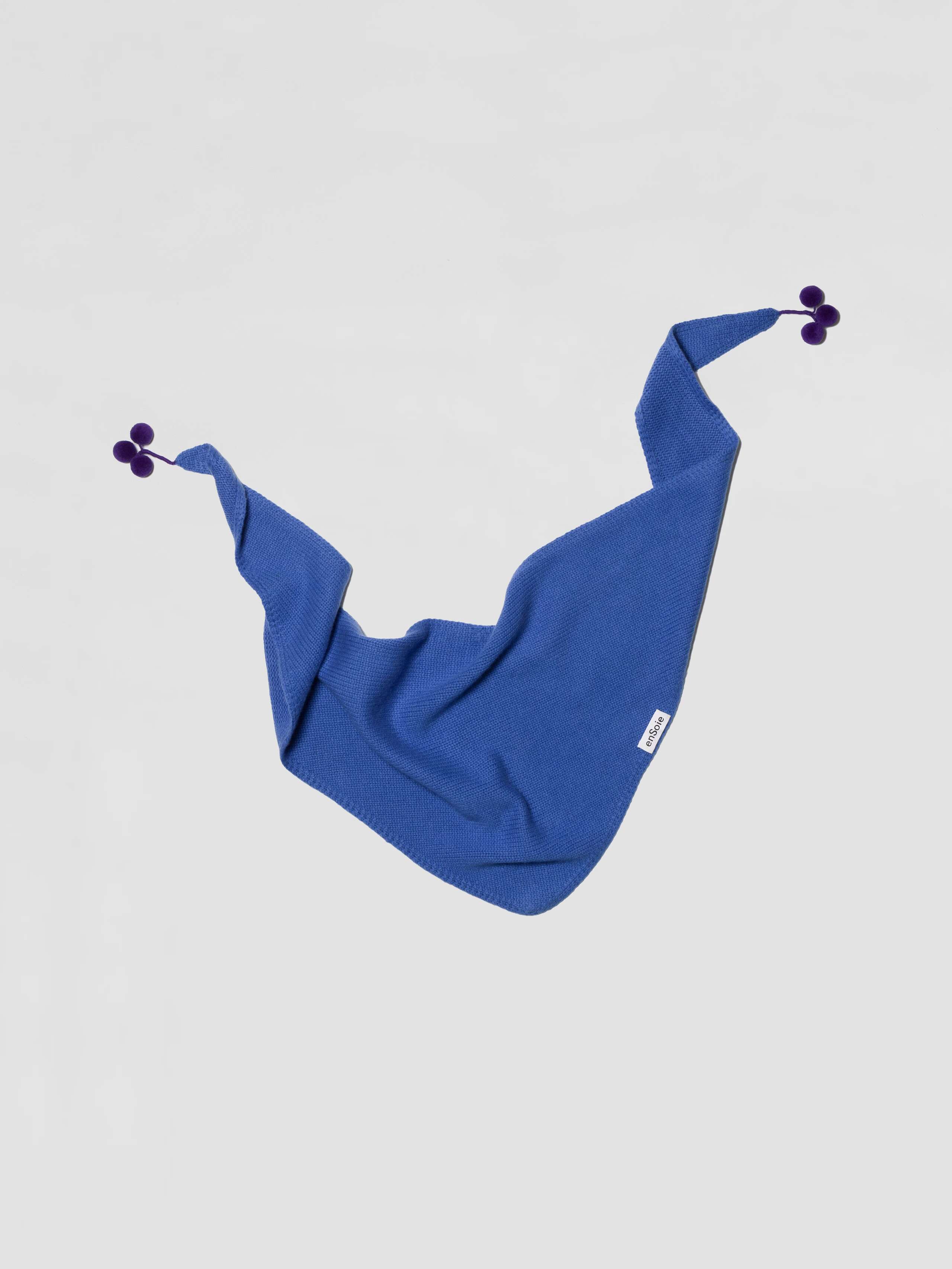 Knitted Pia cashmere triangle scarf with pompon detail in palermo blue