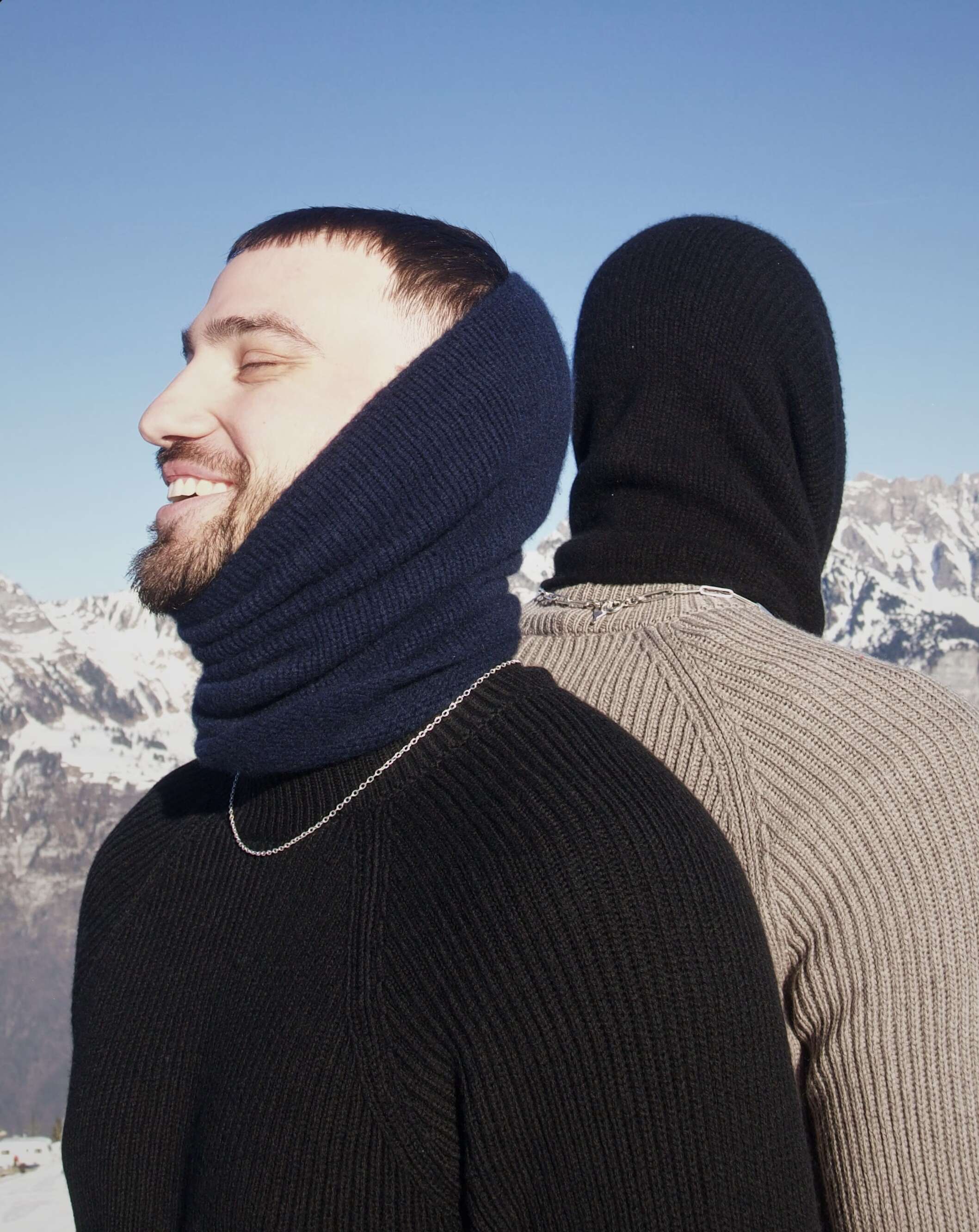 Picture of two young men standing in snow.