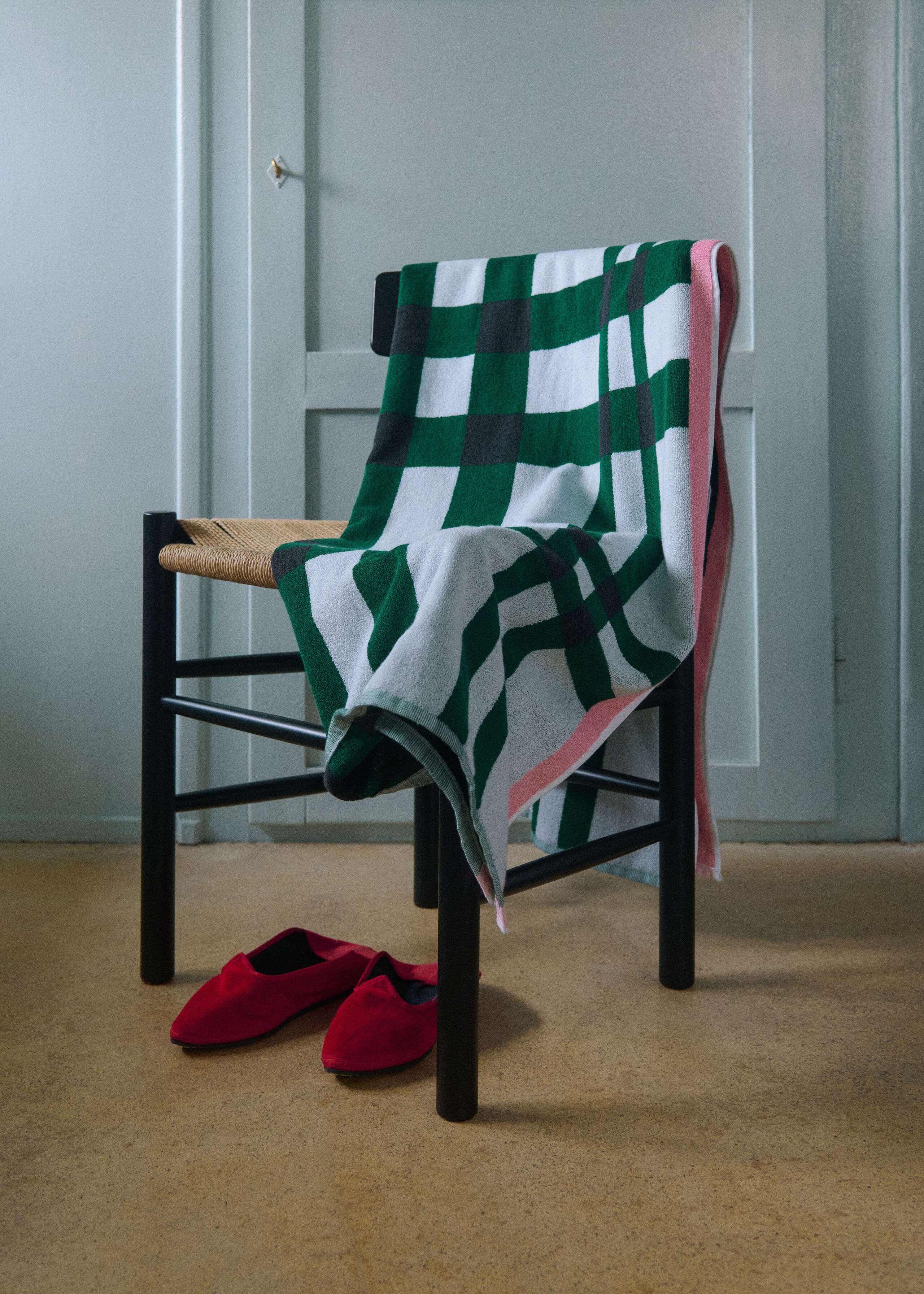 Picture of a bath towel featuring a green vichy check pattern