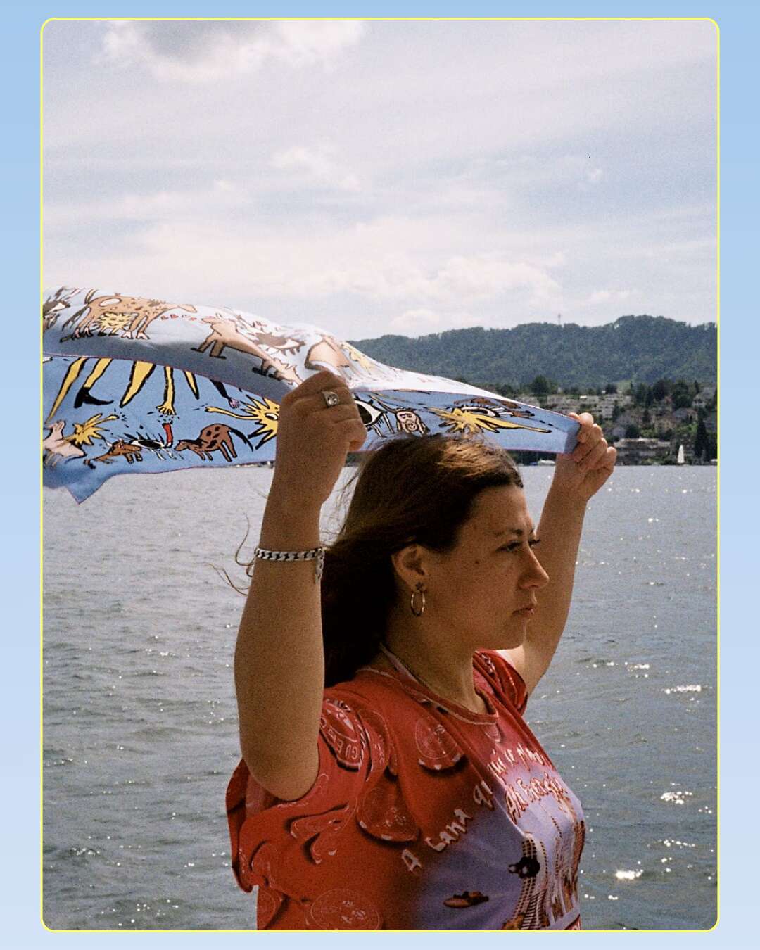 Picture of a young women holding a silk foulard in the wind