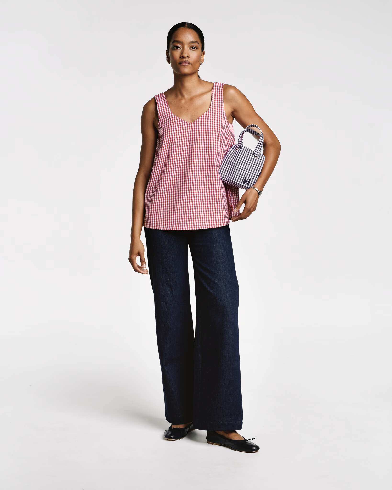 Model wearing the Tia top sleeveless in red vichy check