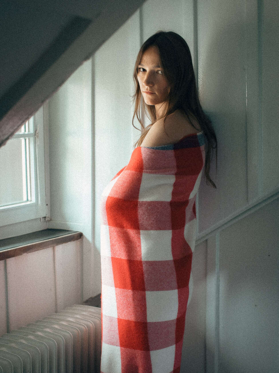 Picture of a women wrapped in a red wool blanket